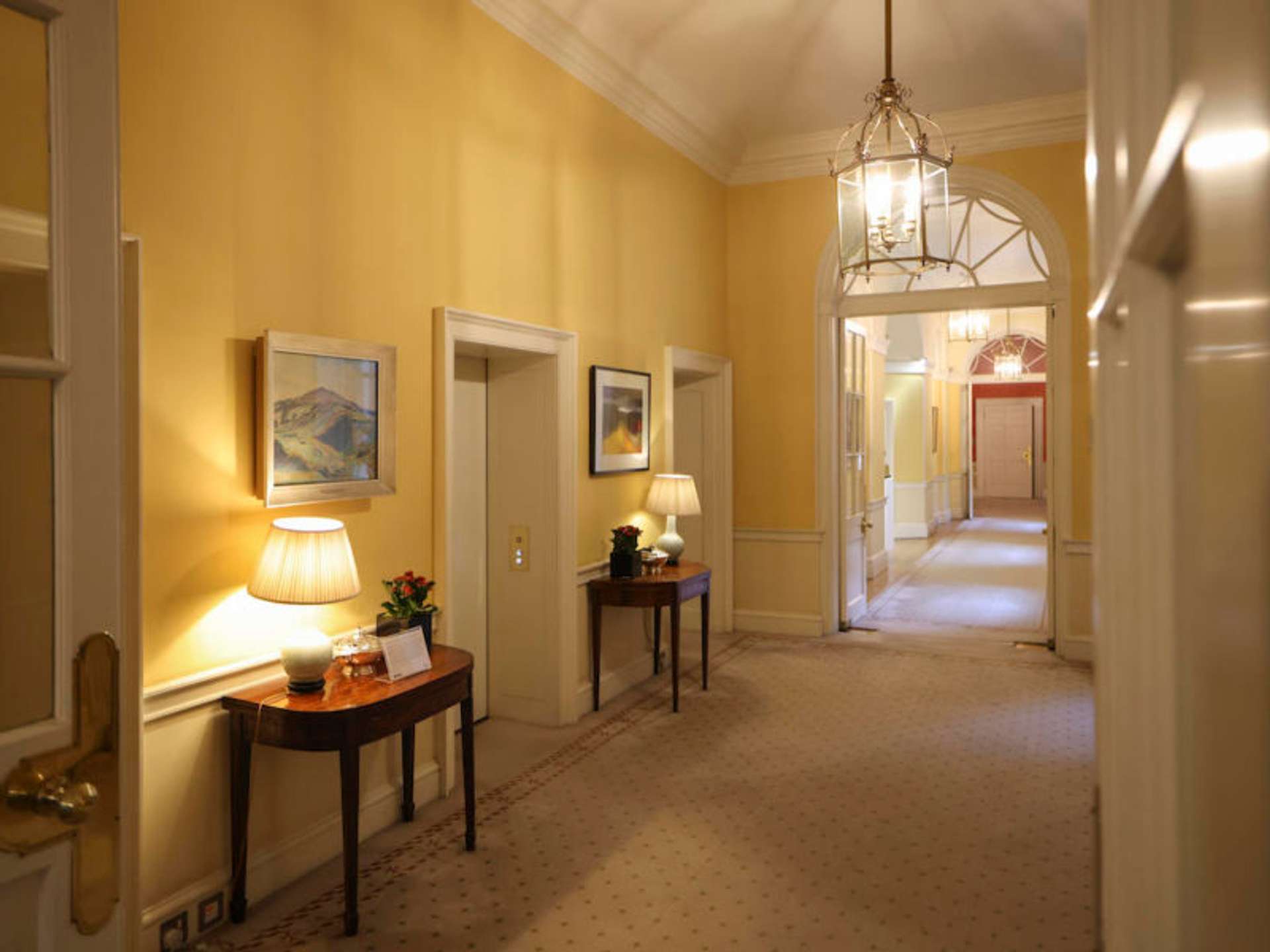 Interior photo of hallway with art on the walls of Downing Street