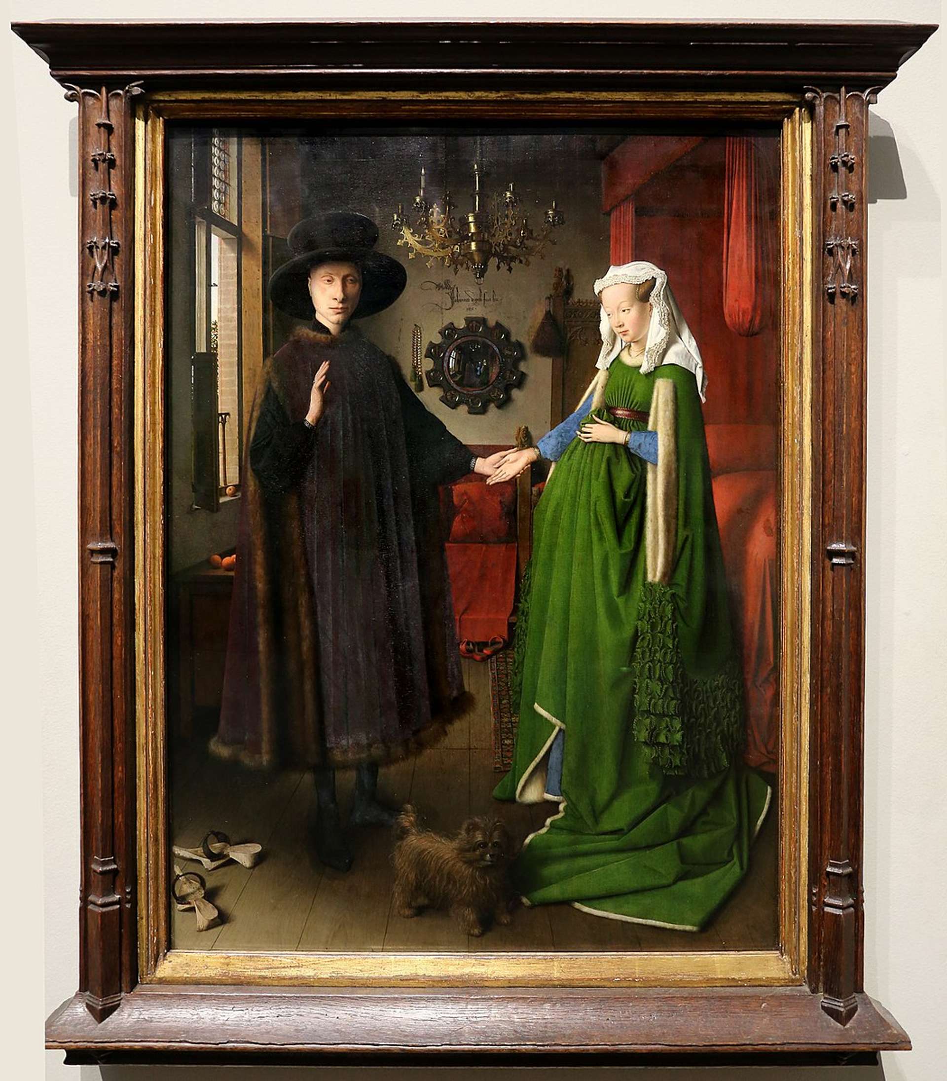 A 15th-century oil painting titled "Arnolfini Portrait" by Jan van Eyck, depicting a wealthy merchant and his wife standing in a room filled with intricate details, including a convex mirror reflecting the couple and two other figures.