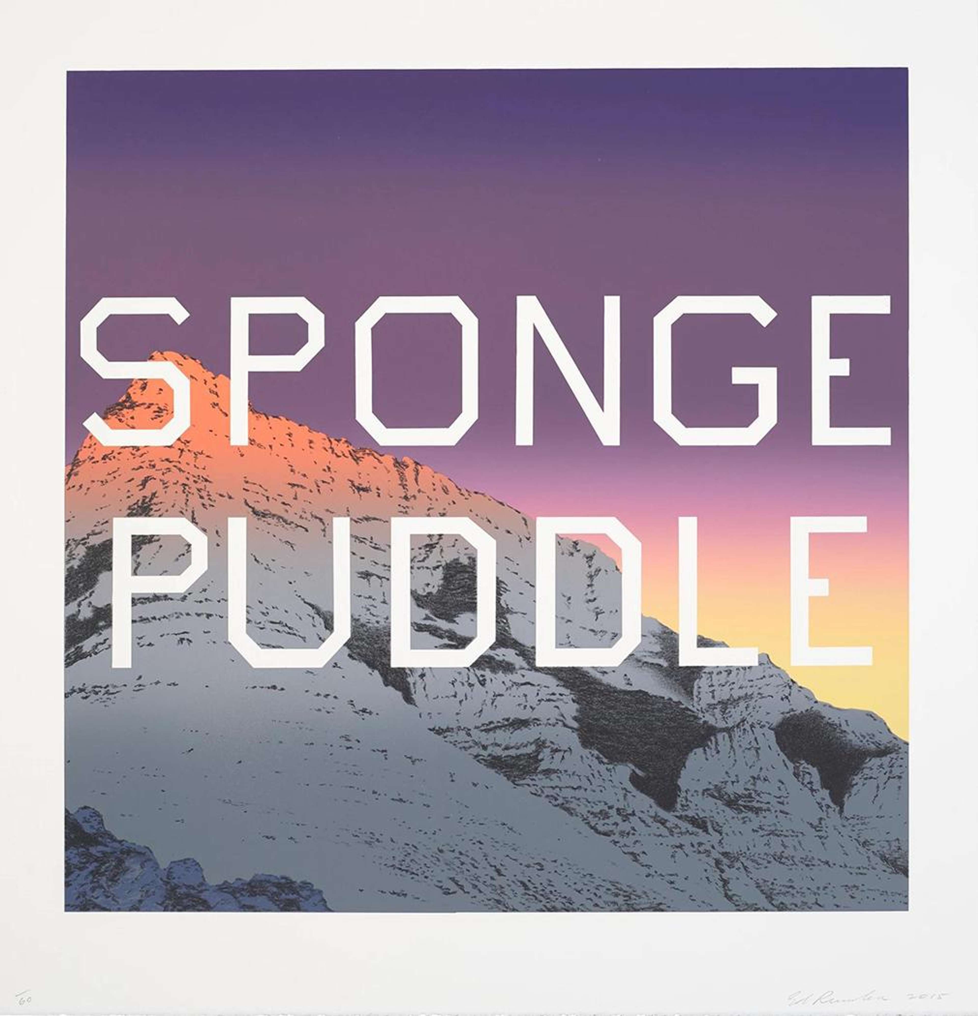 An image of a mountainside in the evening. Orange light catches the tip of the mountain’s peak, and, behind it, the sky turns from purple to yellow. In the centre of the print are the words “Sponge Puddle,” printed in white, angular text.