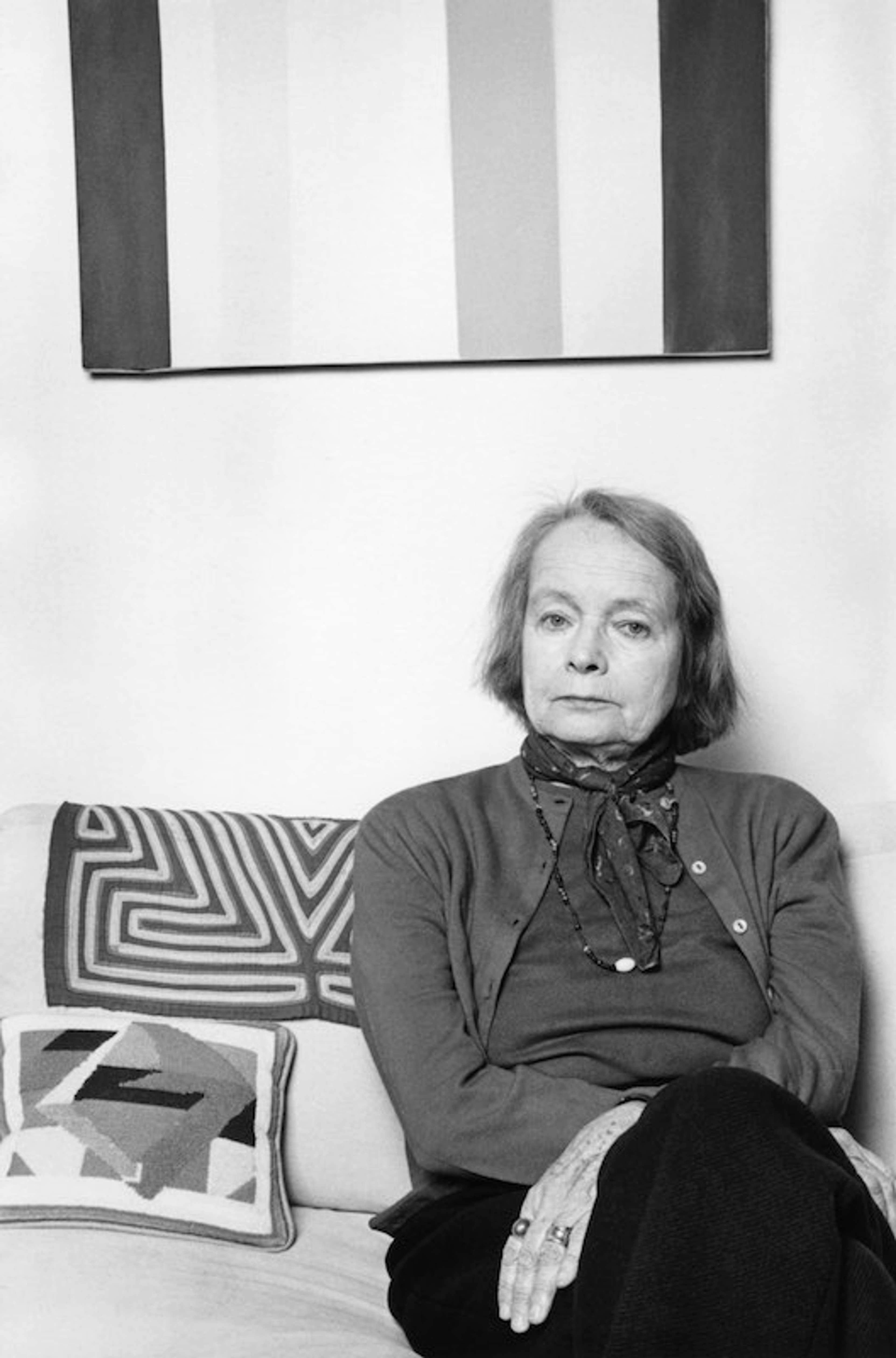 A black and white photgraph portrait of a middle-aged woman sitting with her hand crossed over her lap