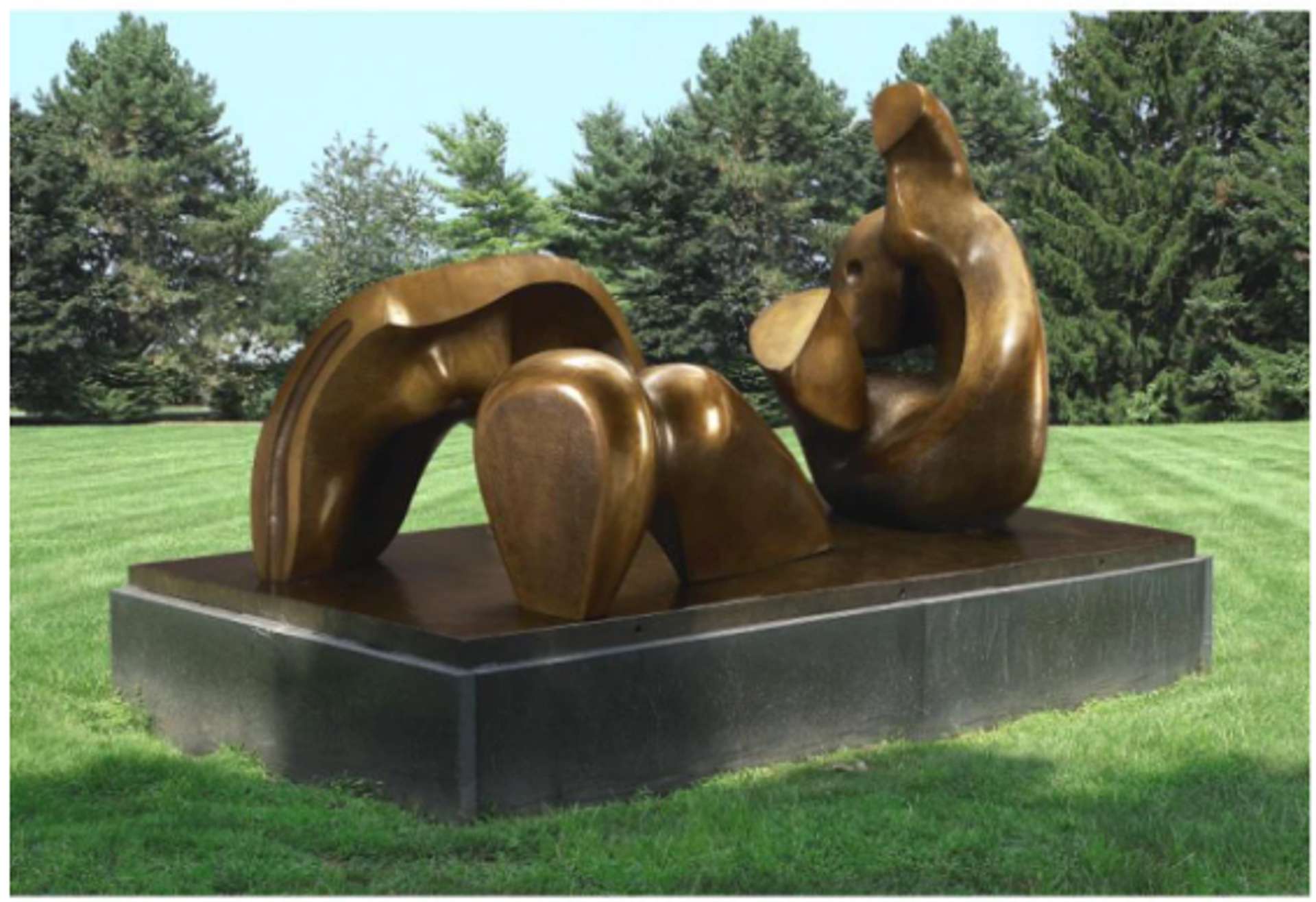  A large-scale bronze sculpture by Henry Moore depicting a reclining figure in three fragmented parts. The sculpture is situated outdoors on an elevated pedestal.