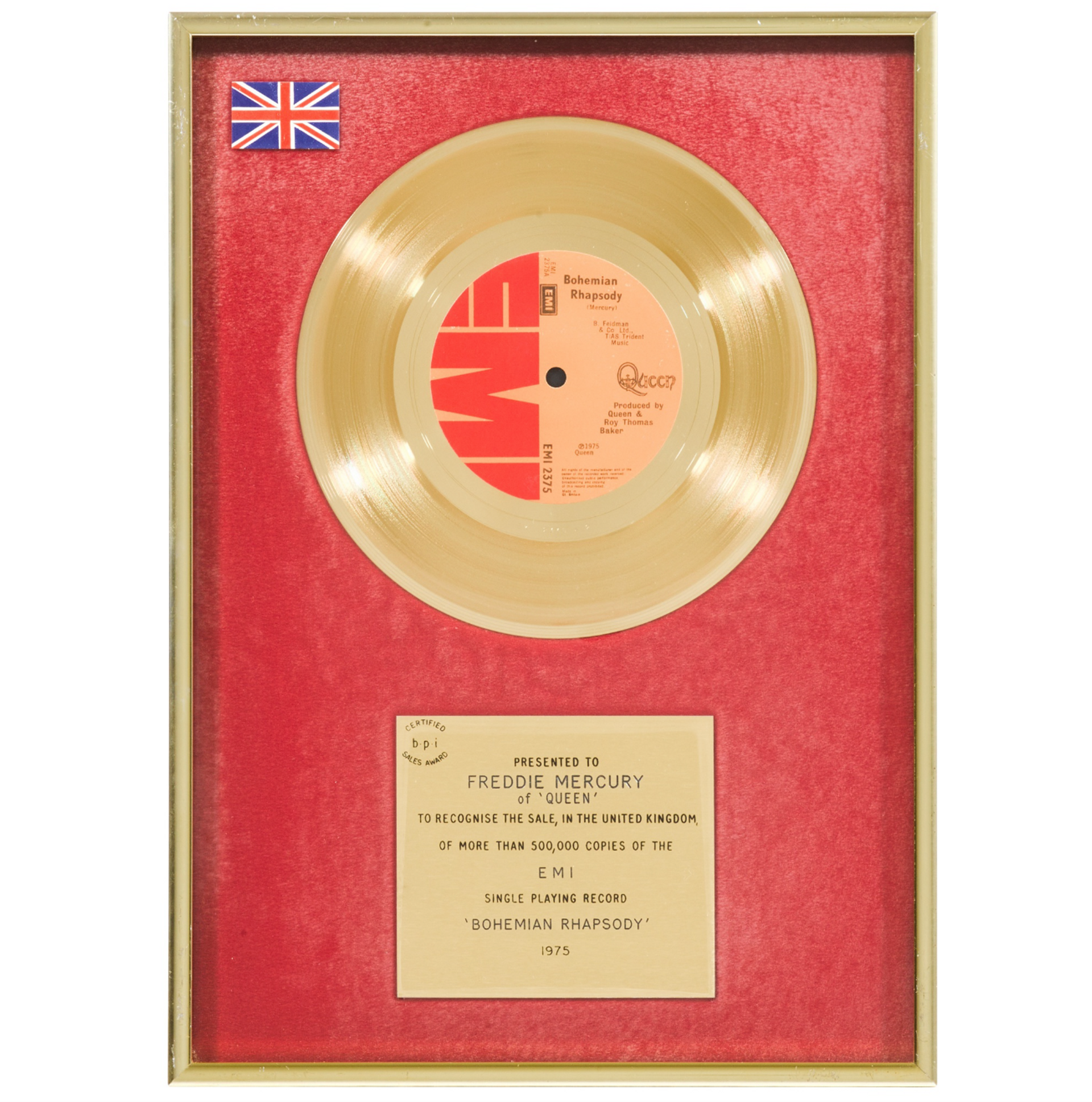 A framed award, with a golden CD and a plaque against a red background, given to Freddie Mercury.