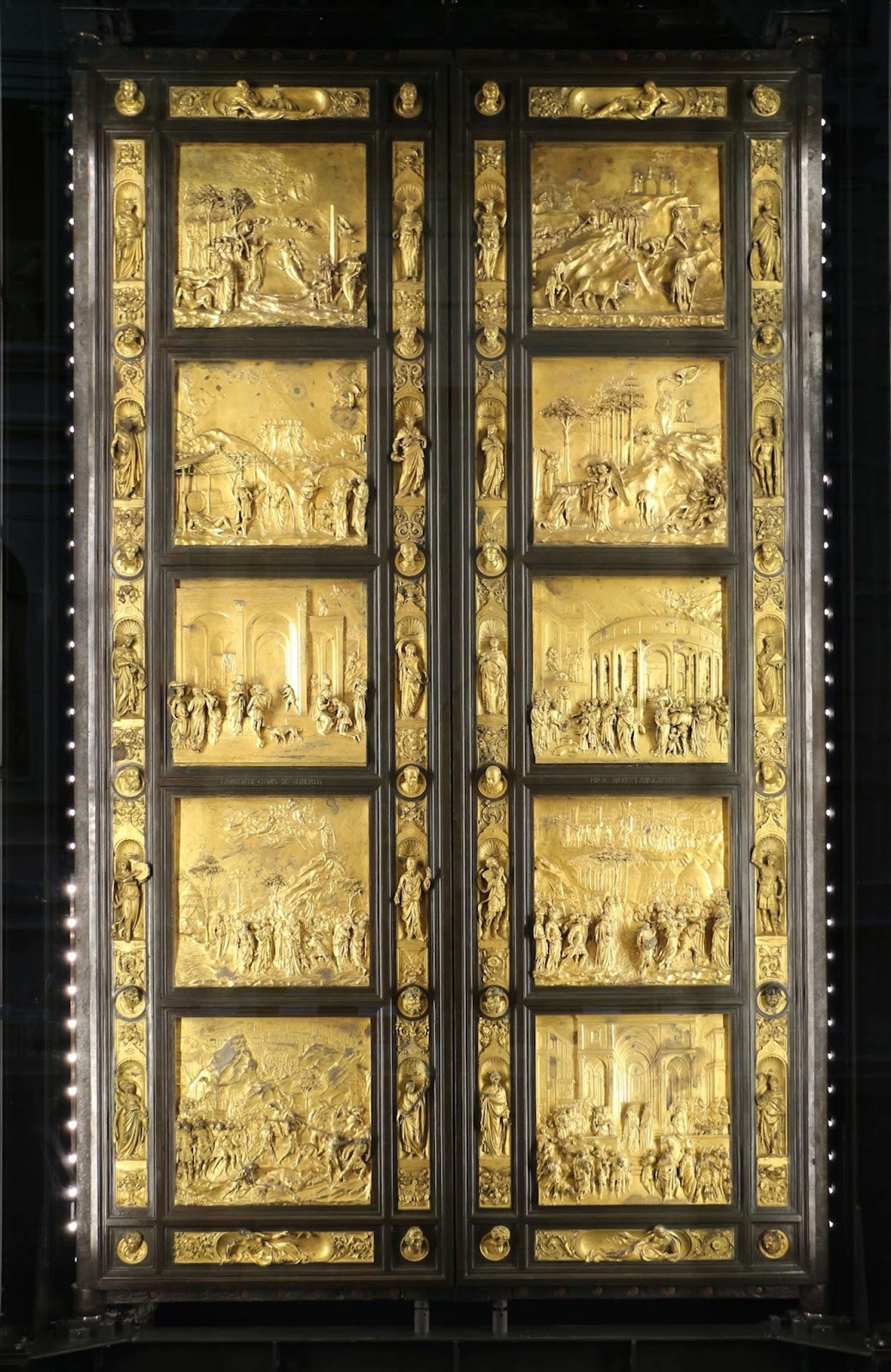 A photograph of The Gates Of Paradise (1452) by Lorenzo Ghiberti, a set of large bronze doors intricately depicting biblical scenes.