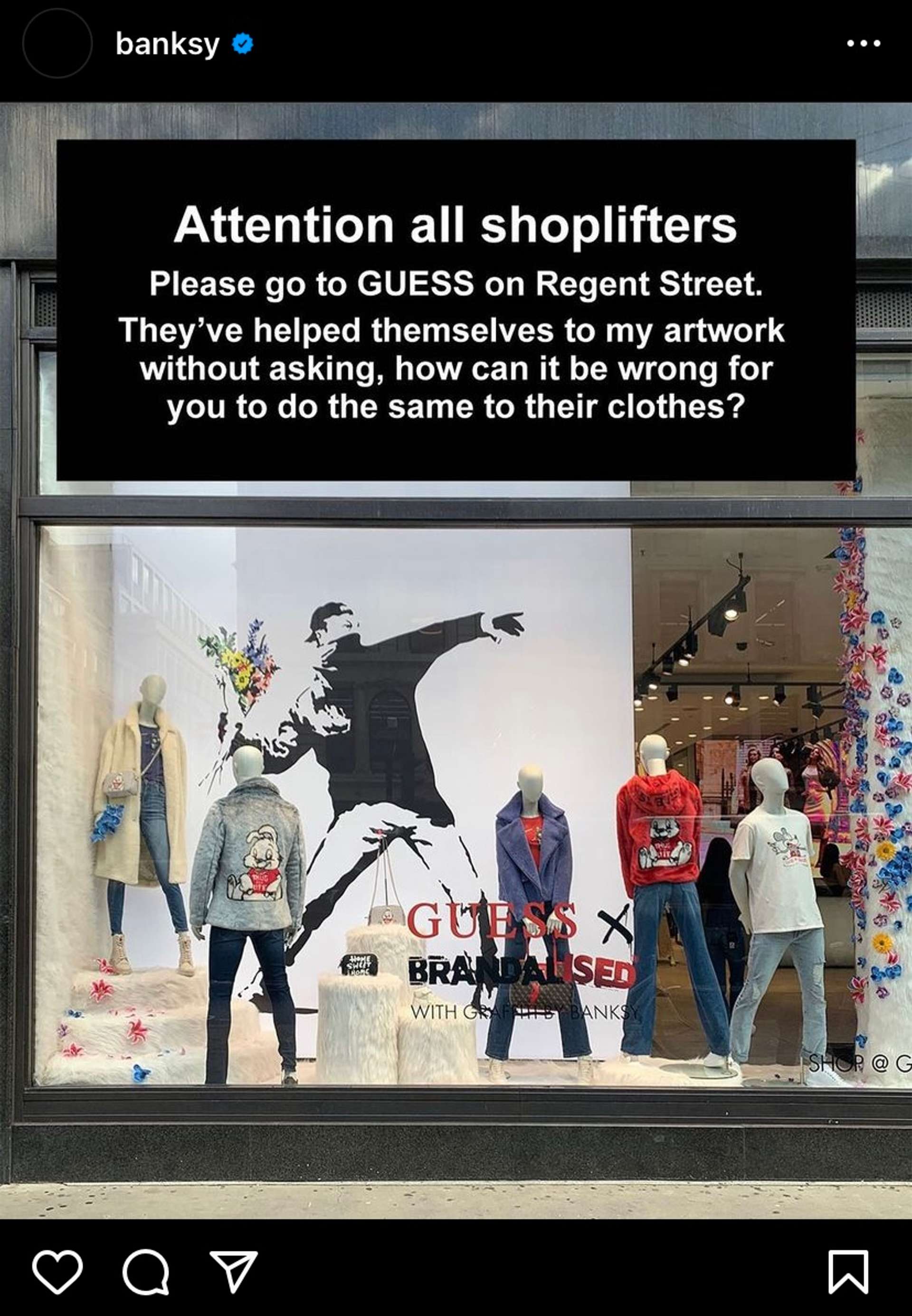 A screen shot from Banksy's instagram post showing the storefront of GUESS which has used his iconic motif of a spray painted man throwing a bunch of flowers as a backdrop to their mannequins in the window