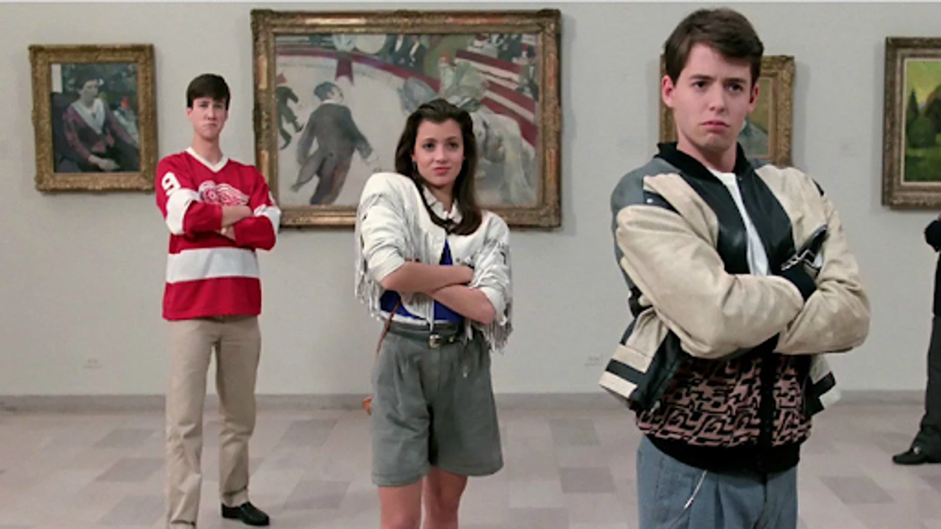 Photograph from the film Ferris Bueller’s Day Off. Three students with their arms folded, staring at art.