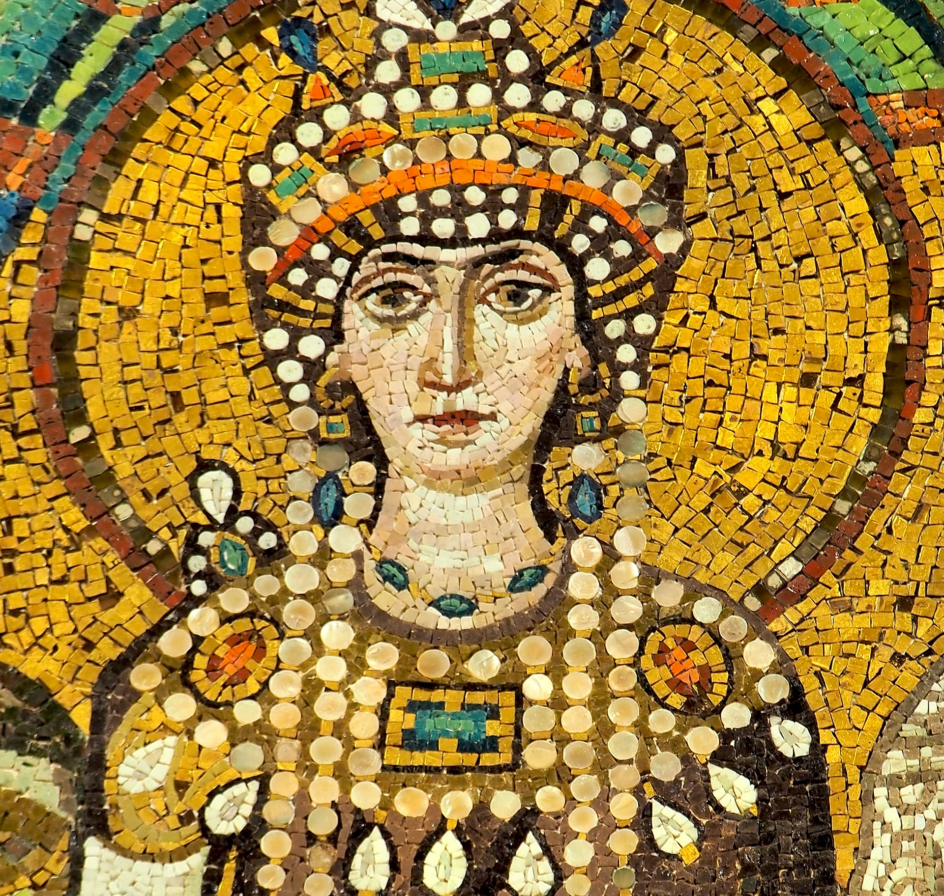 An antique mosaic of Empress Theodora in the Byzantine style. Theodora is shown with dark hair and eyes, fully dressed in jewellery including a pearl headpiece.