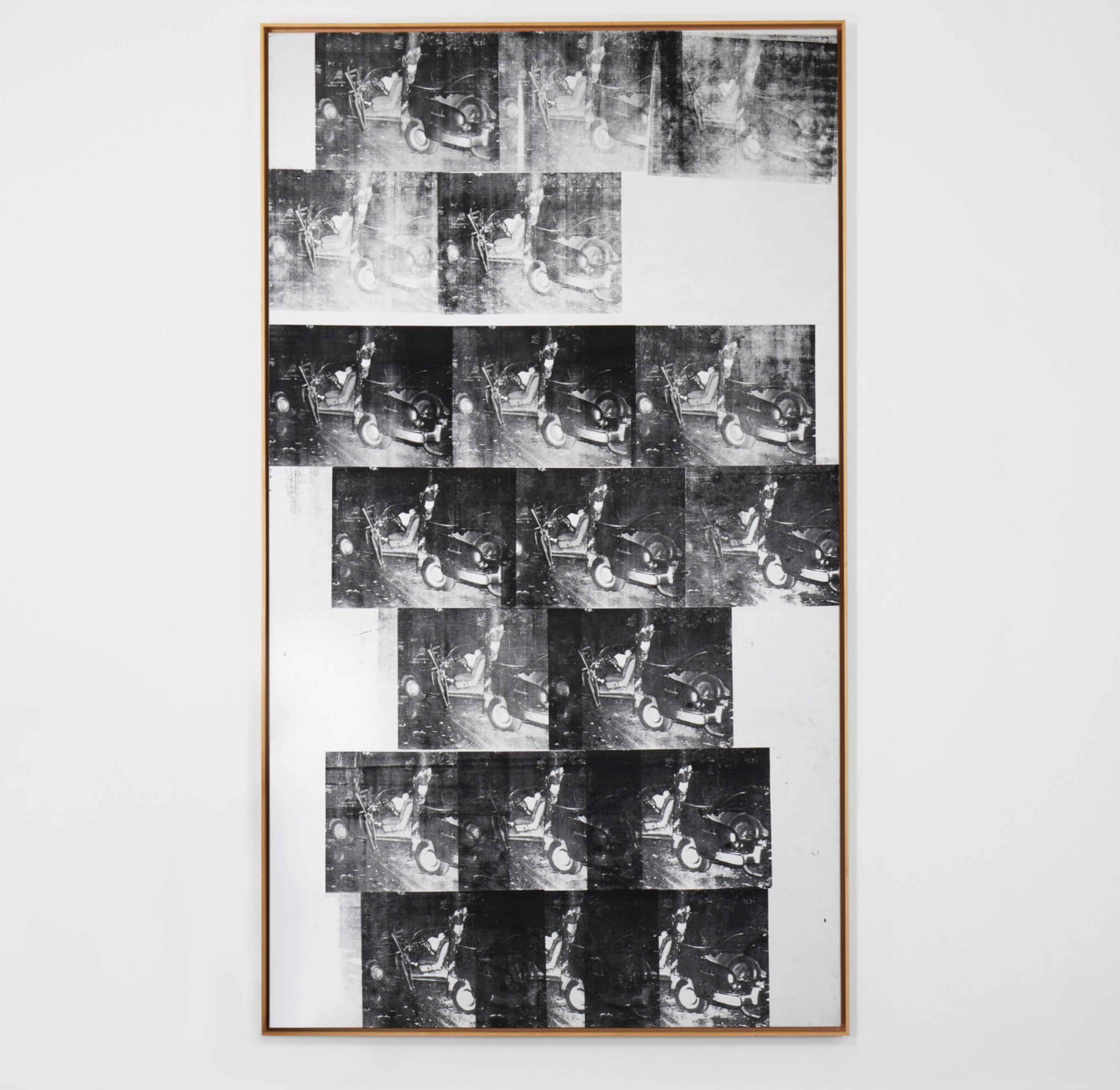 An image of White Disaster by Andy Warhol, a monochrome work showing dozens of repeating images of a car crash.