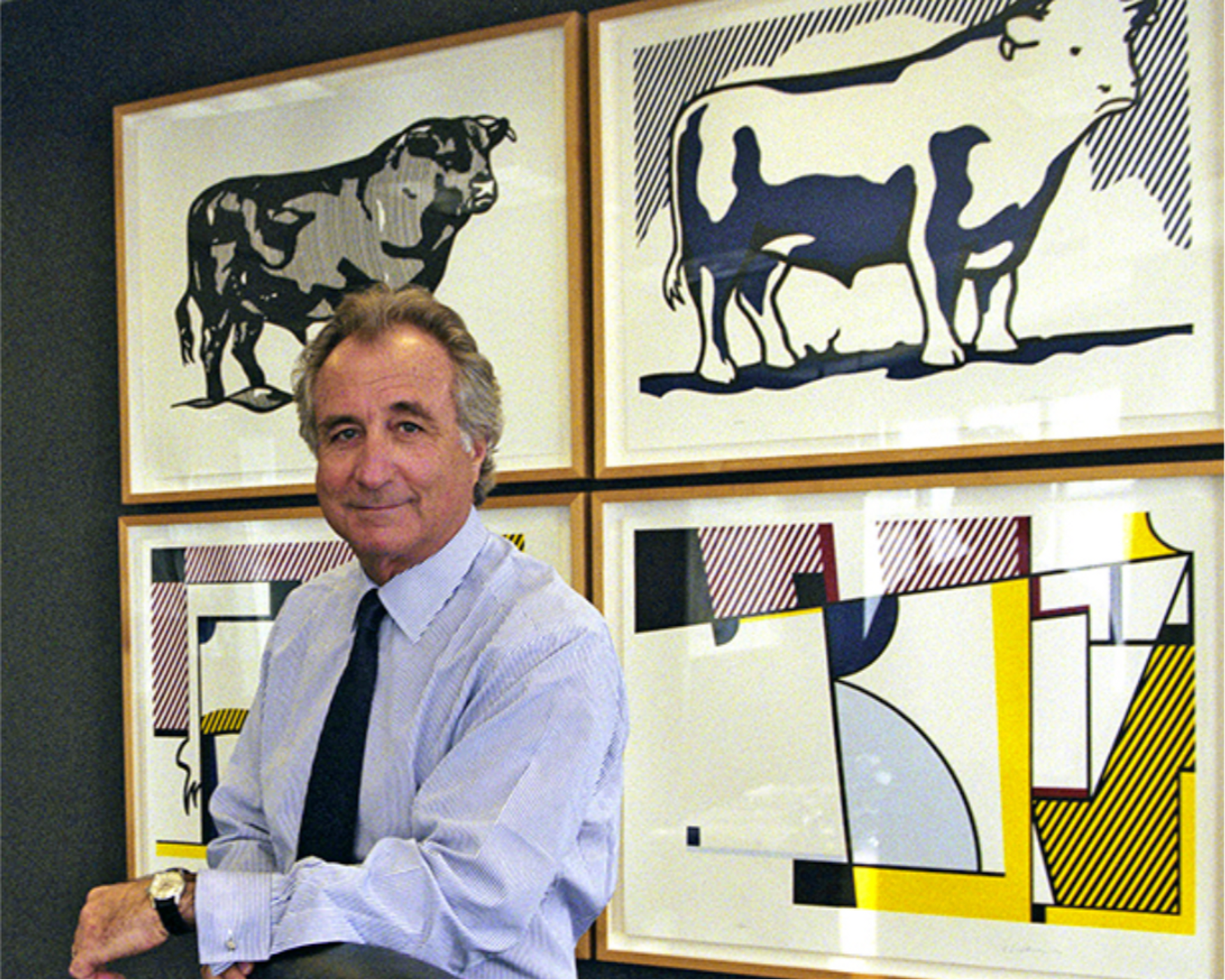 Bernie Madoff standing in front of his editions of Roy Lichtenstein’s Bull Profile Series.