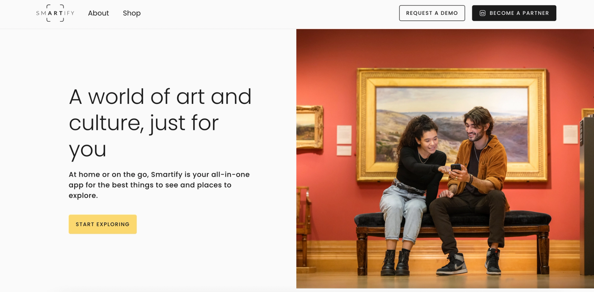 A screenshot of the landing page for the platform Smartify. To the right, a couple is shown at a museum and, to the left, the slogan "A world of art and culture, just for you"
