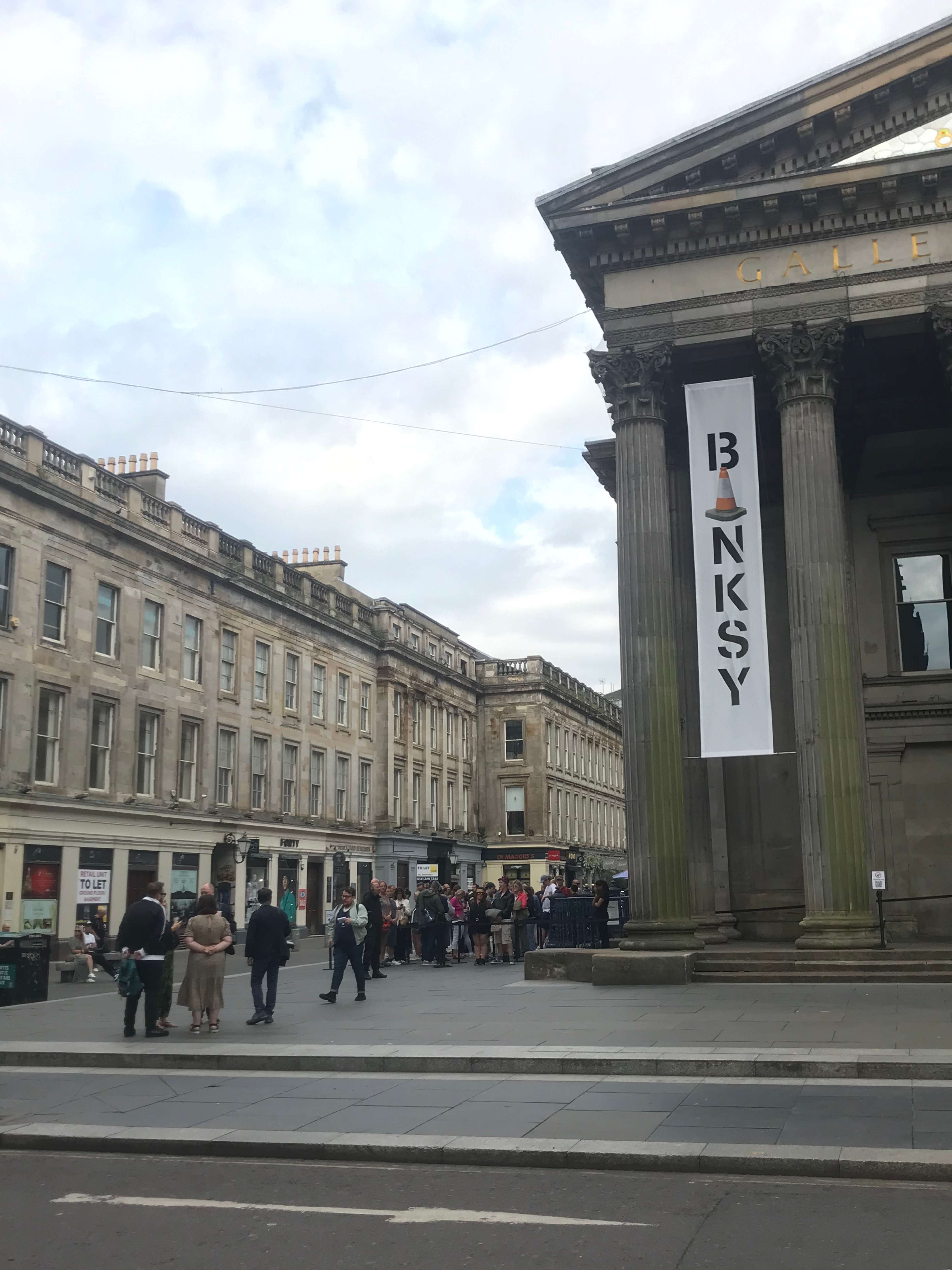 A photograph of the queue outside Banksy's CUT & RUN Exhibition at the GoMA.