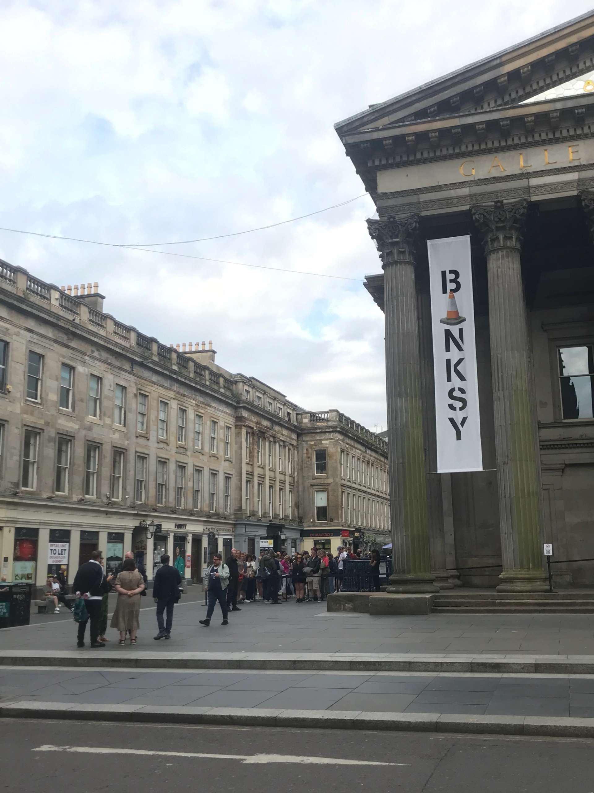 A photograph of the queue outside Banksy's CUT & RUN Exhibition at the GoMA.