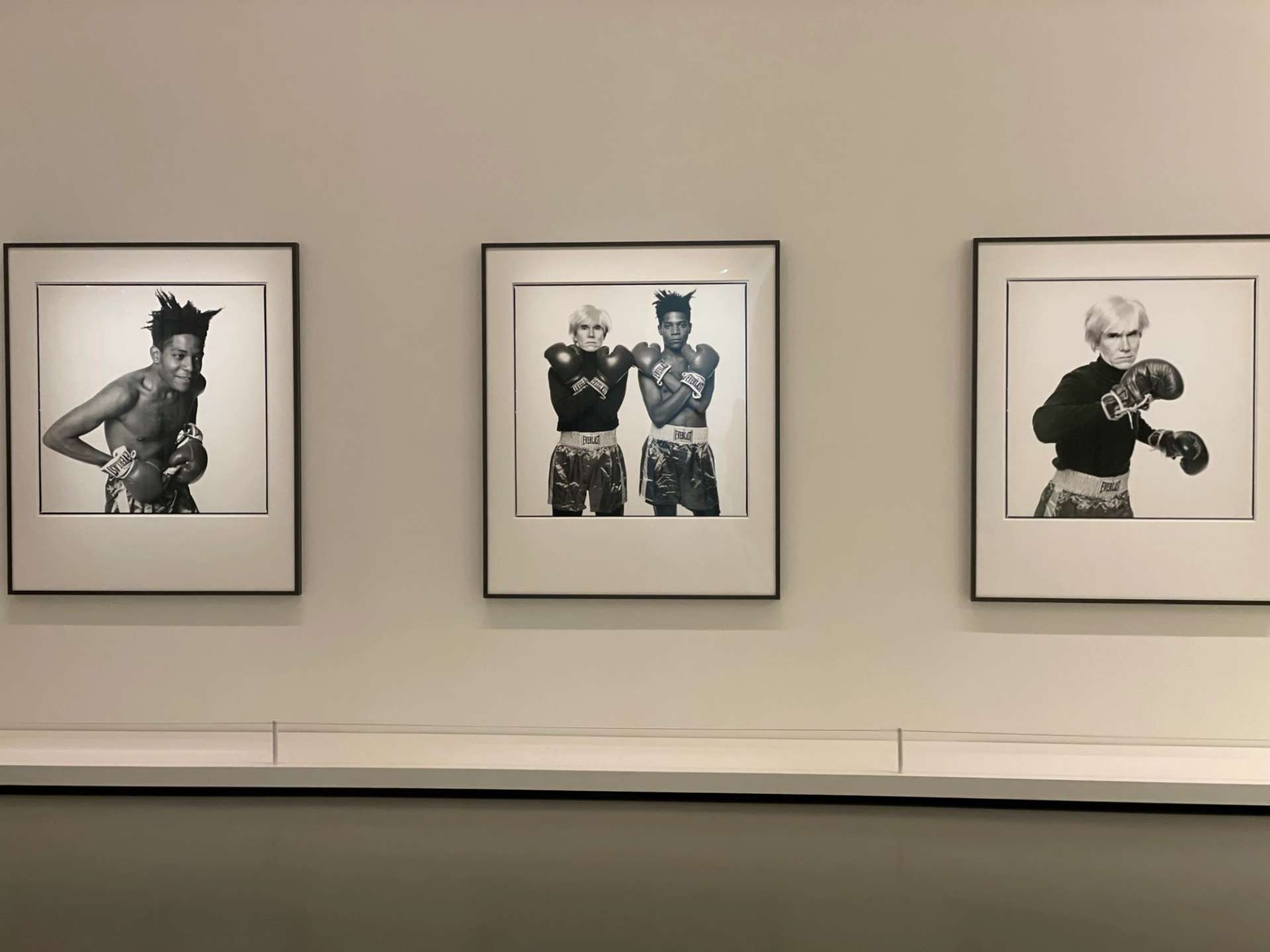 Three black and white photographs of Andy Warhol and Jean-Michele Basquiat