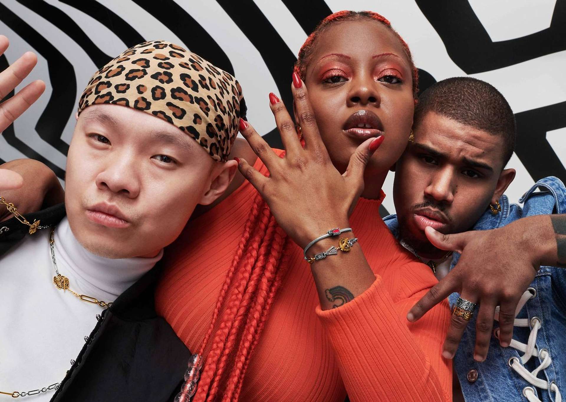 A photograph of three models wearing different styles of jewellery from Pandora’s collaboration with Keith Haring’s estate.