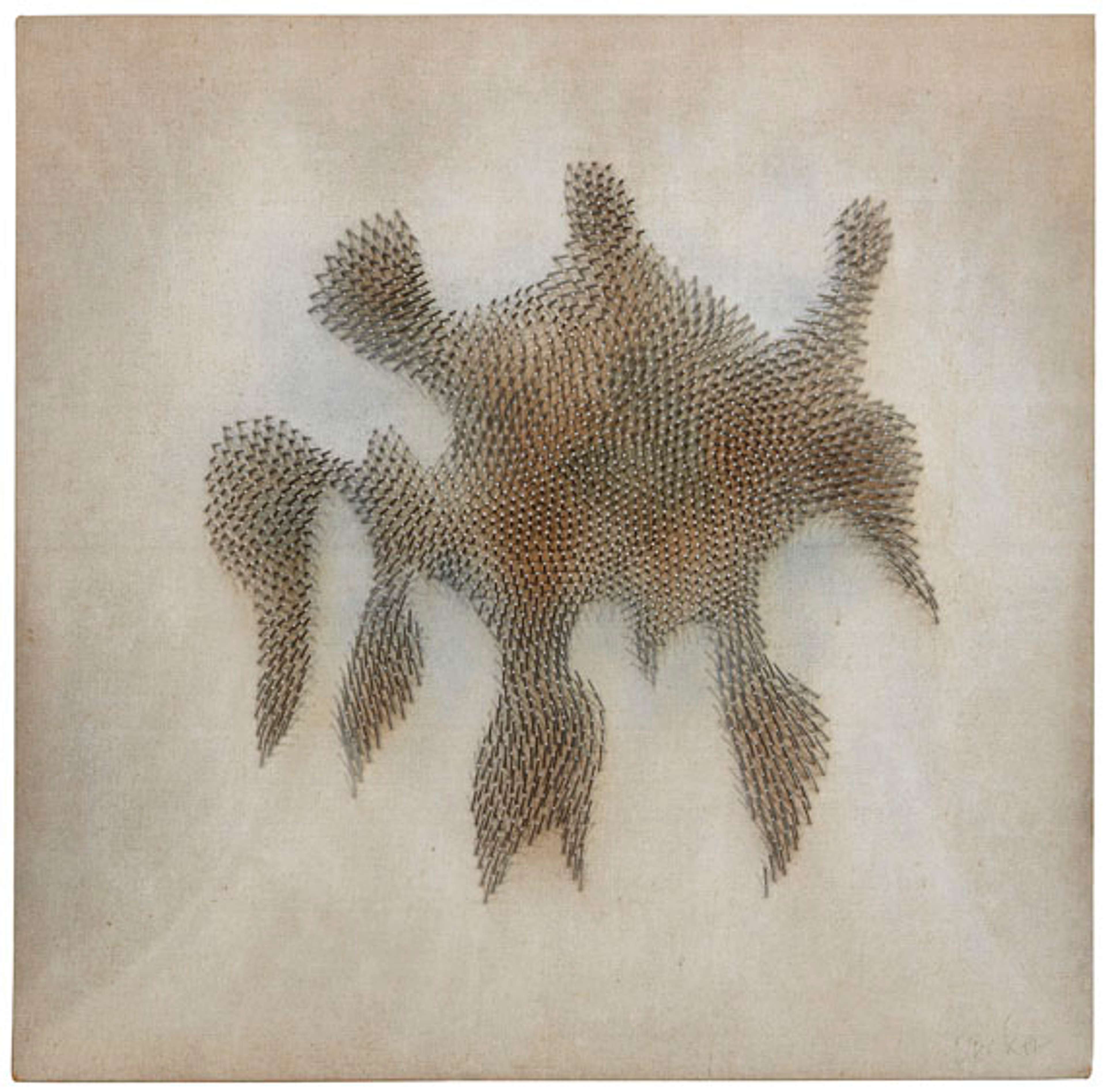 A dramatic starburst pattern of nails radiates outward from a central point and appears to drip down the textured off-white canvas, creating a dynamic visual field suggesting both cosmic expansion and concentrated energy. Light catches the nail heads differently across the surface, enhancing the sense of movement and creating darker and lighter areas of shadow between them.