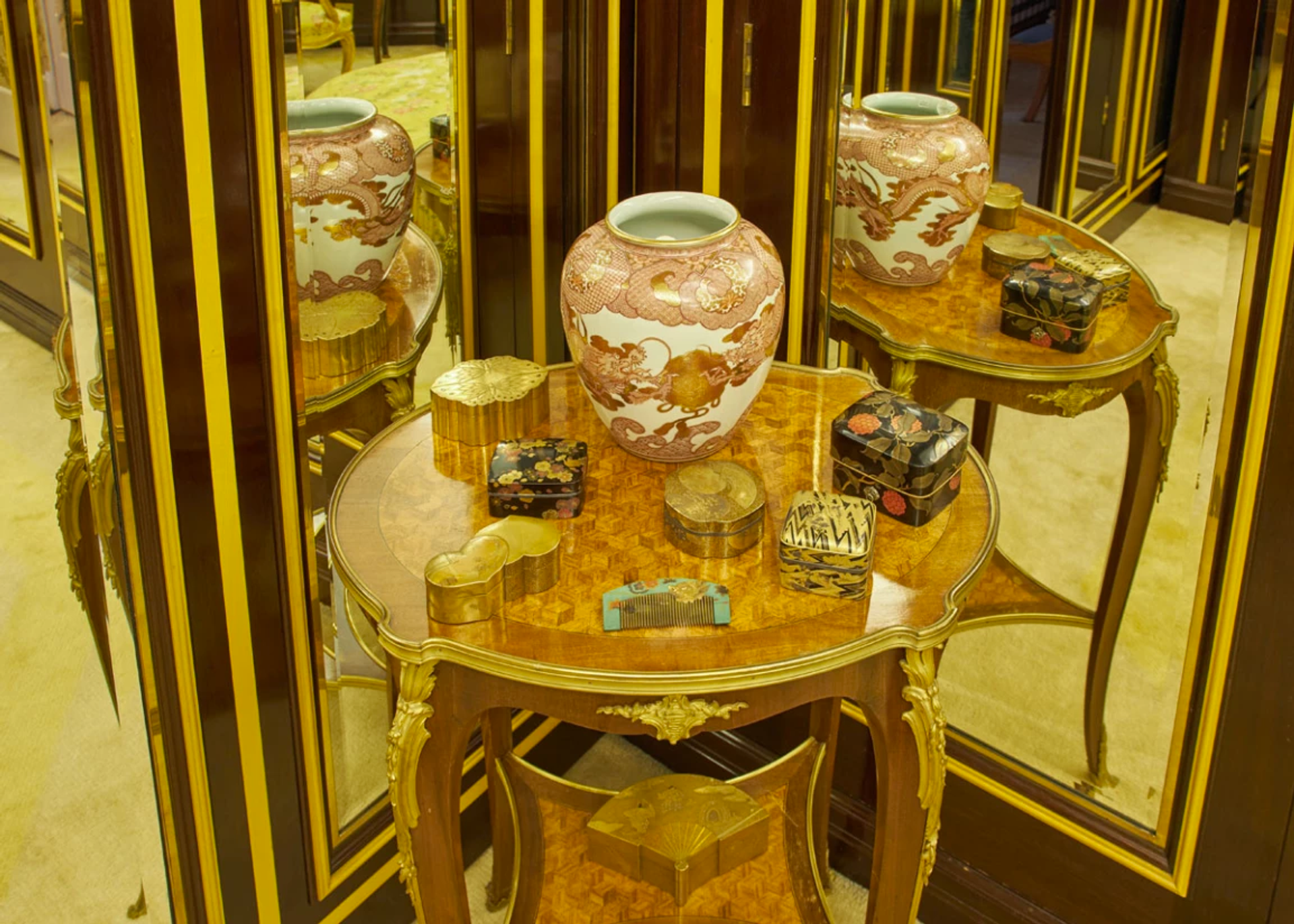 An image of Mercury's dressing room, showing a mirrored table covered in small lacquer boxes in the Japanese style.