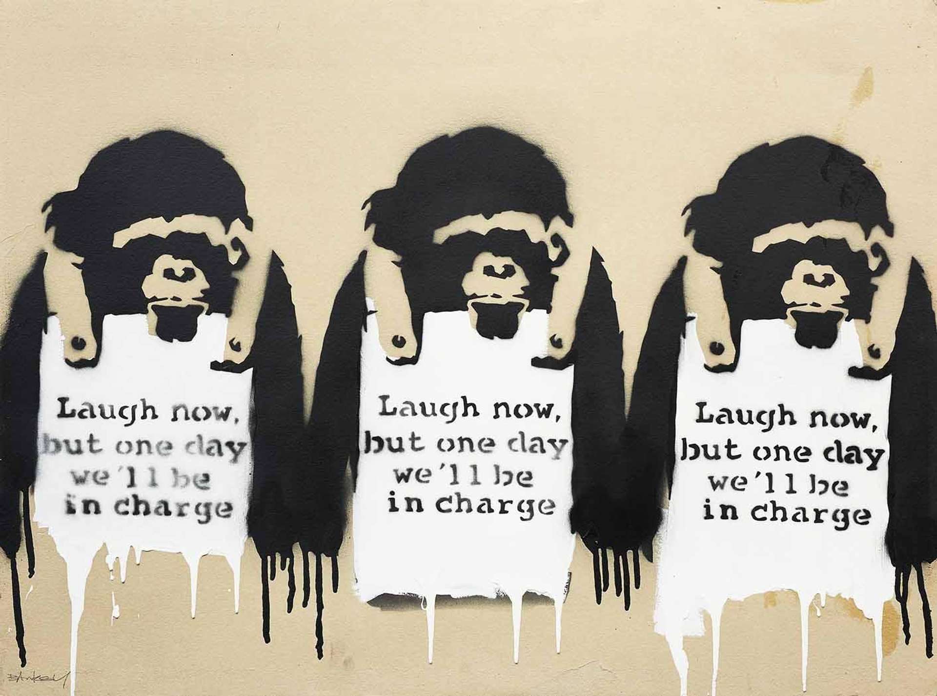 Three of Banksy’s spray painted  monkeys, wearing signs that say “Laugh Now, But One Day We’ll Be In Charge”