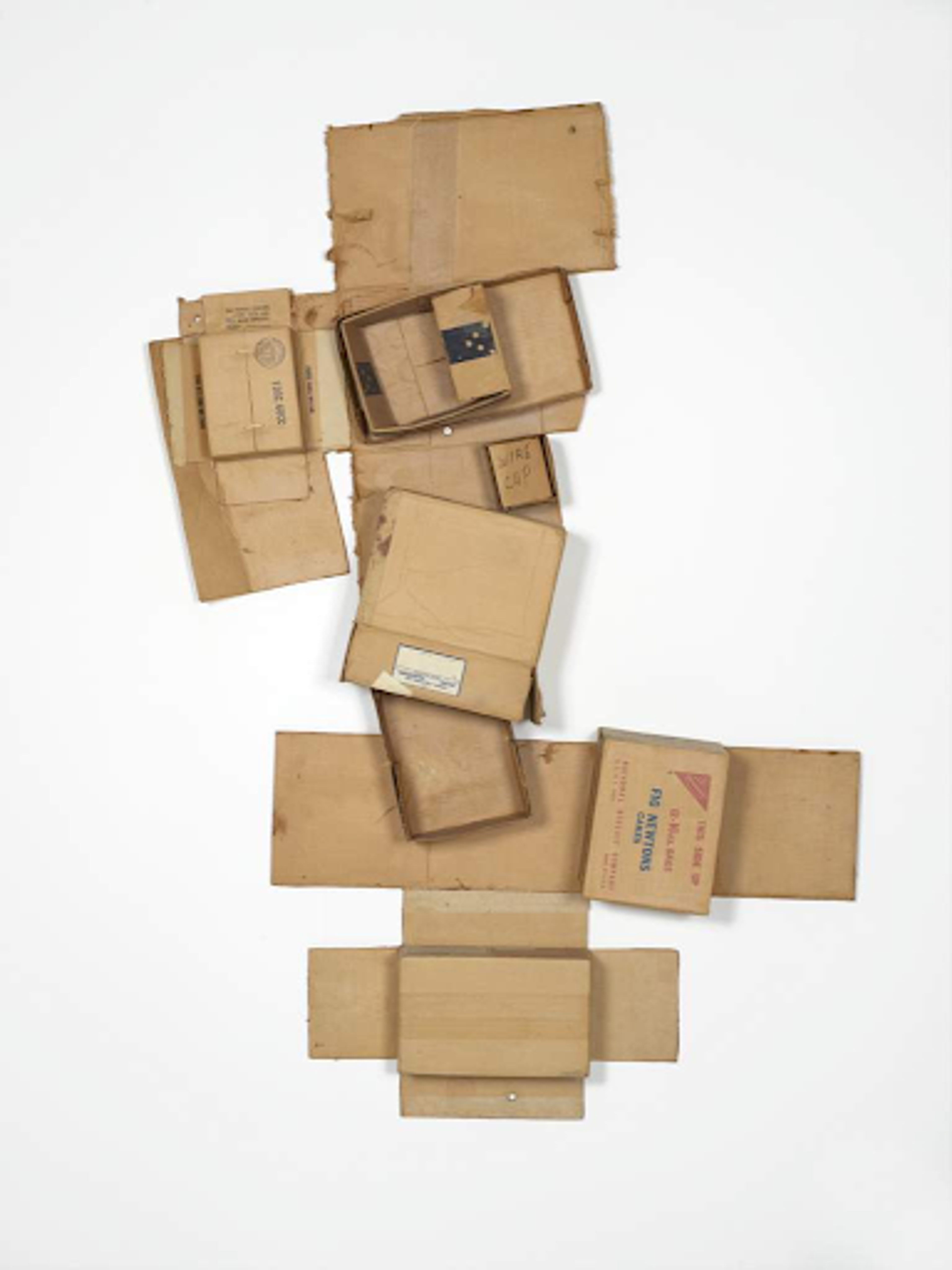 Robert Rauschnberg’s Spanish Stuffed / Mode / Plus. An assemblage of cardboard boxes stacked vertically