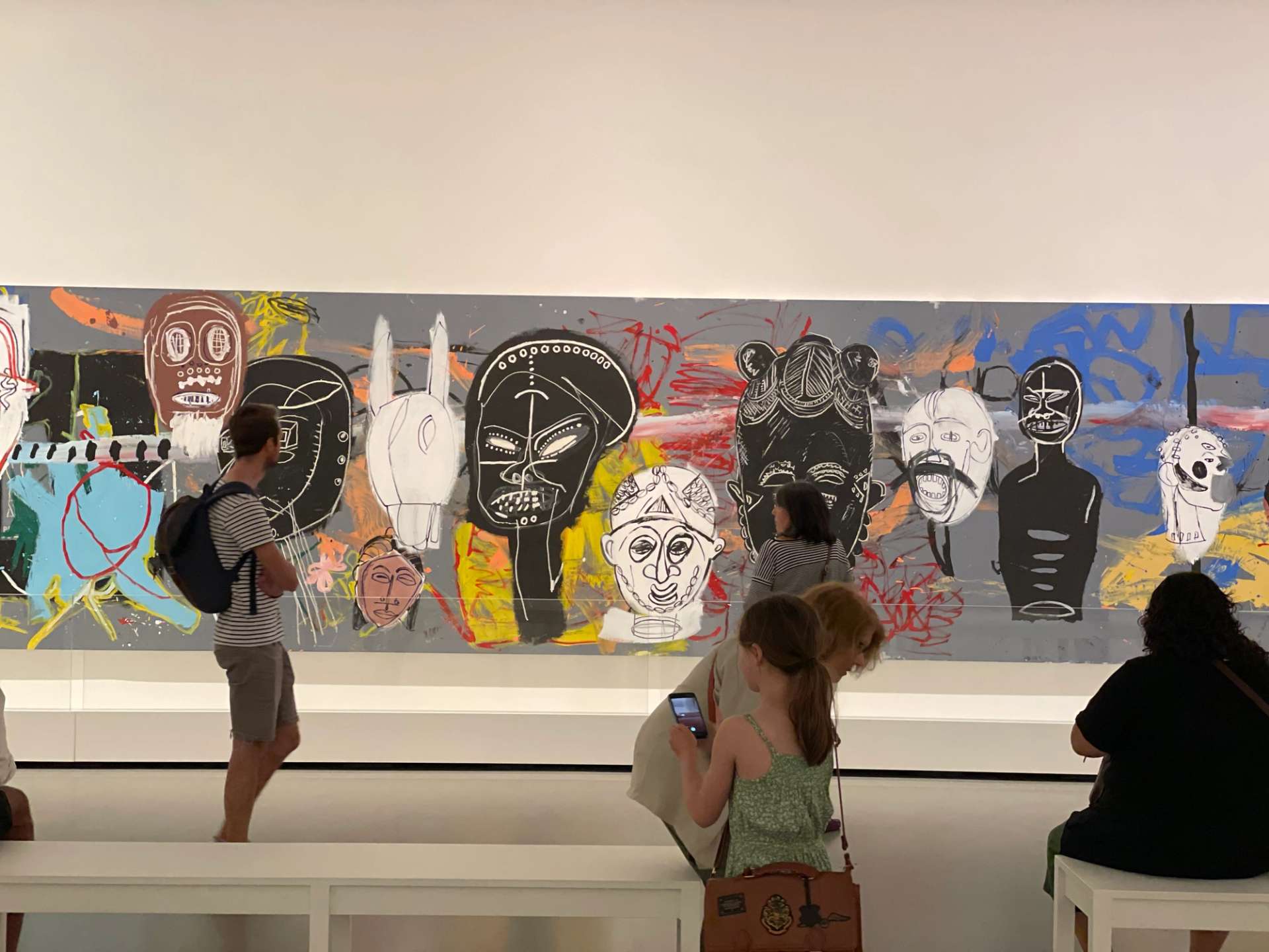 Installation view of Painting Four Hands including African Masks by Basquiat and Warhol