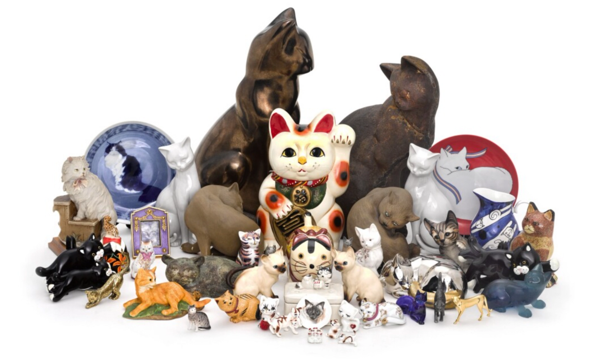 Twenty-nine figures of cats in a whimsical variety of decorative styles.