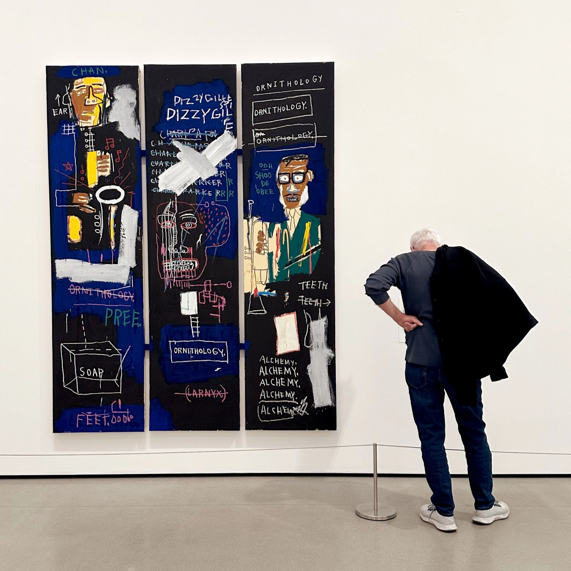 This painting by Basquiat is an homage to the great horn players Charlie Parker and Dizzy Gillespie. On the left is Parker with his alto saxophone and on the right is Gillespie with his trumpet. 