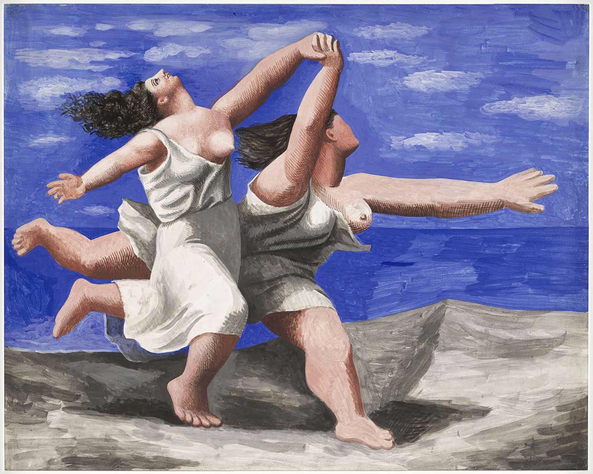 This painting by Picasso shows two female figures running on a beach against a blue sky and sea, holding hands.