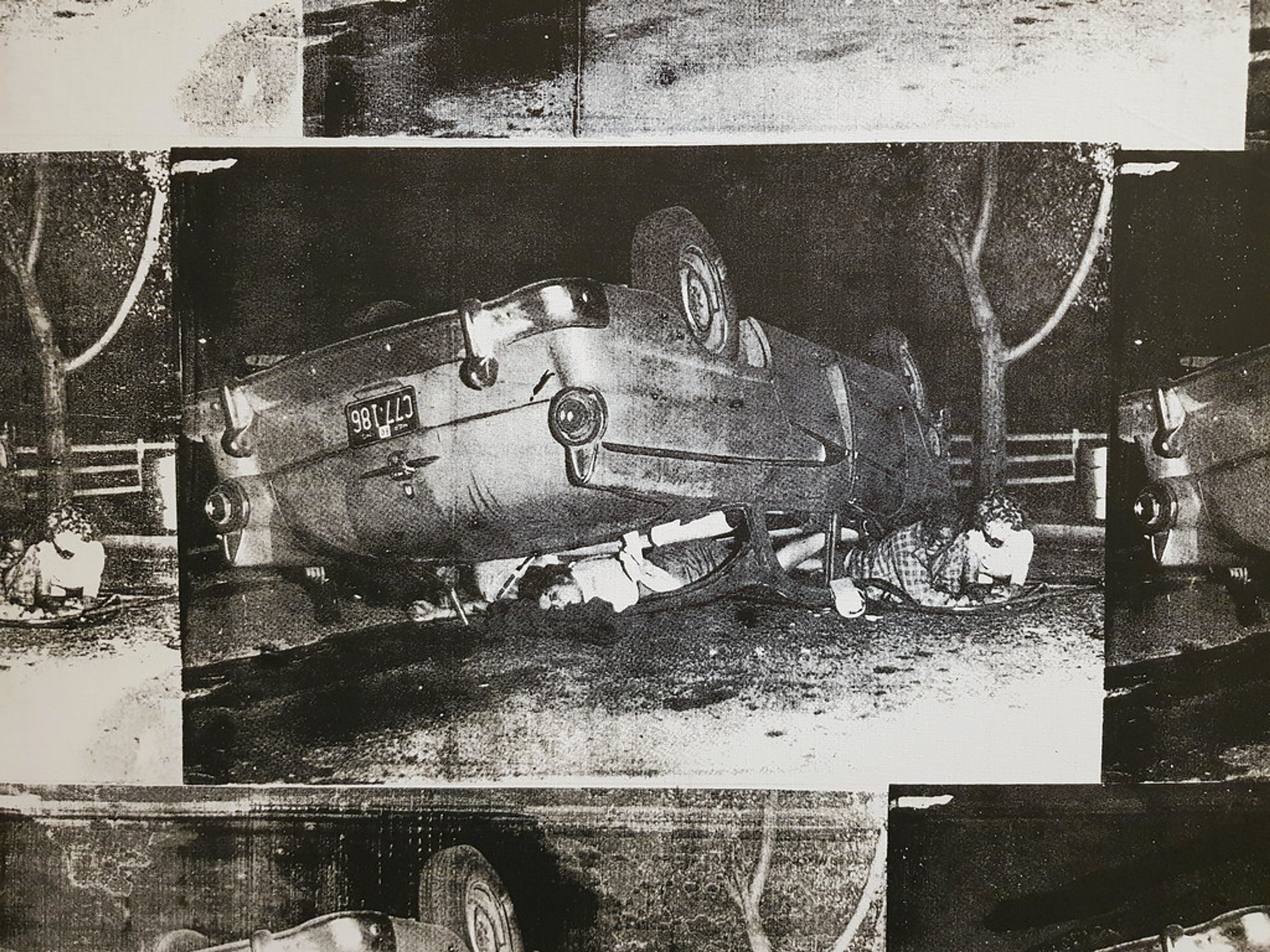 An image of the artwork 5 deaths by Andy Warhol, showing an overturned car. Several bodies can be seen in the wreckage.