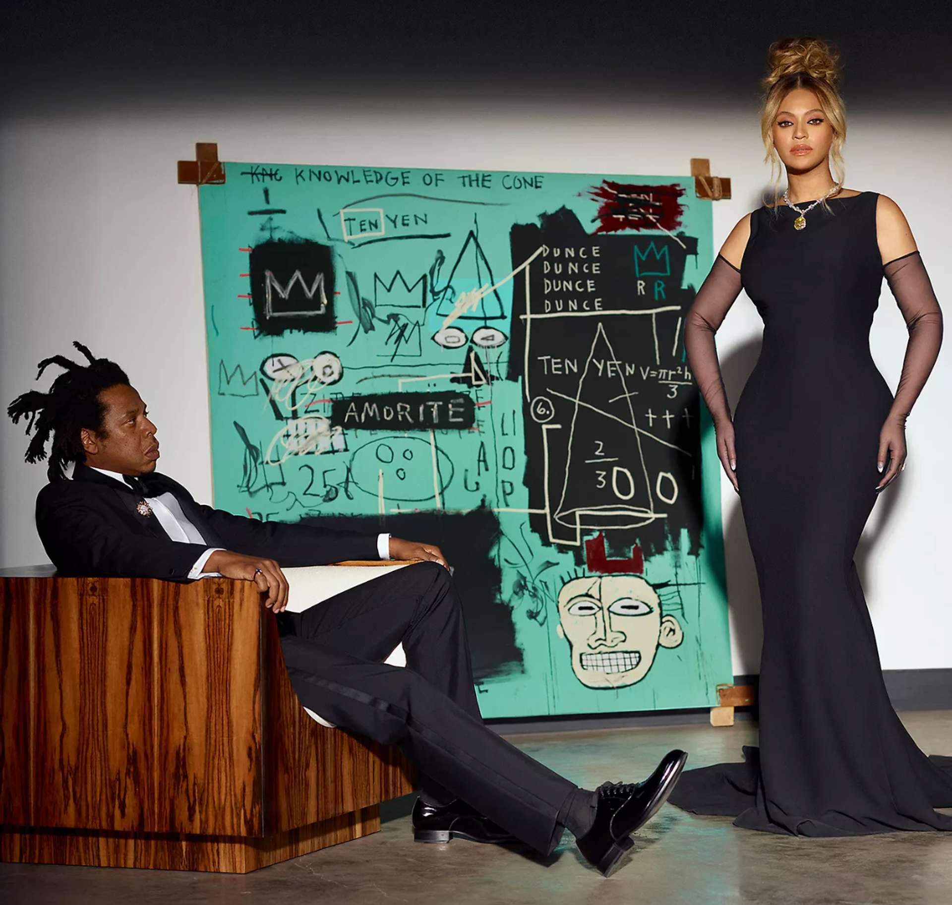 A photograph of the musicians Jay-Z and Beyoncé, dressed in formal attire, standing in front of the painting Equals Pi by Basquiat
