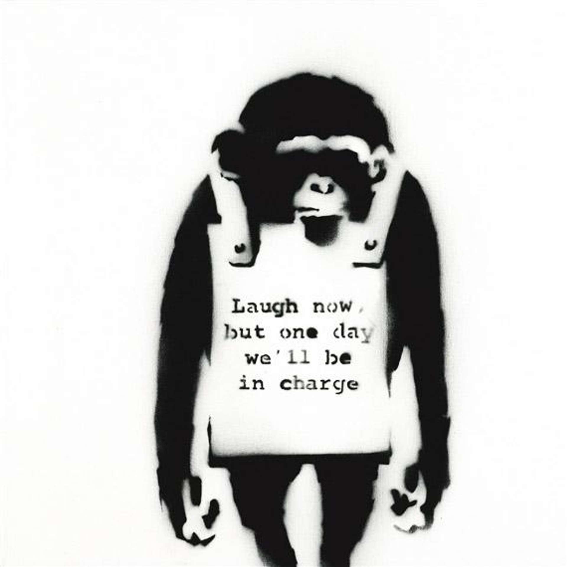 A black and white graffiti stencil image by Banksy depicting a chimpanzee with a sandwich board reading: “Laugh Now But One Day We'll Be In Charge”.