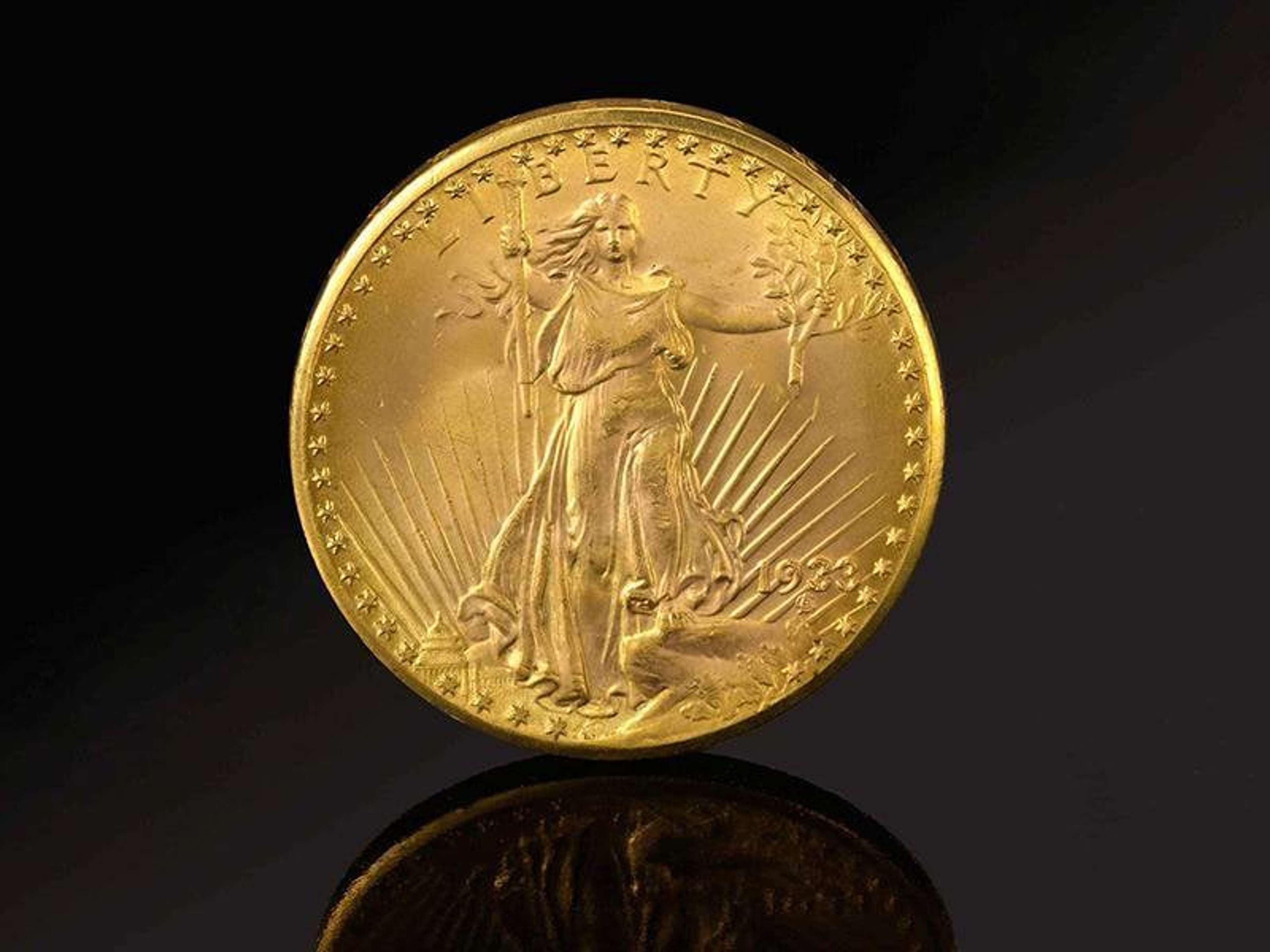 Gold coin with an embossed female 'liberty' stepping out of the water holding a branch and staff