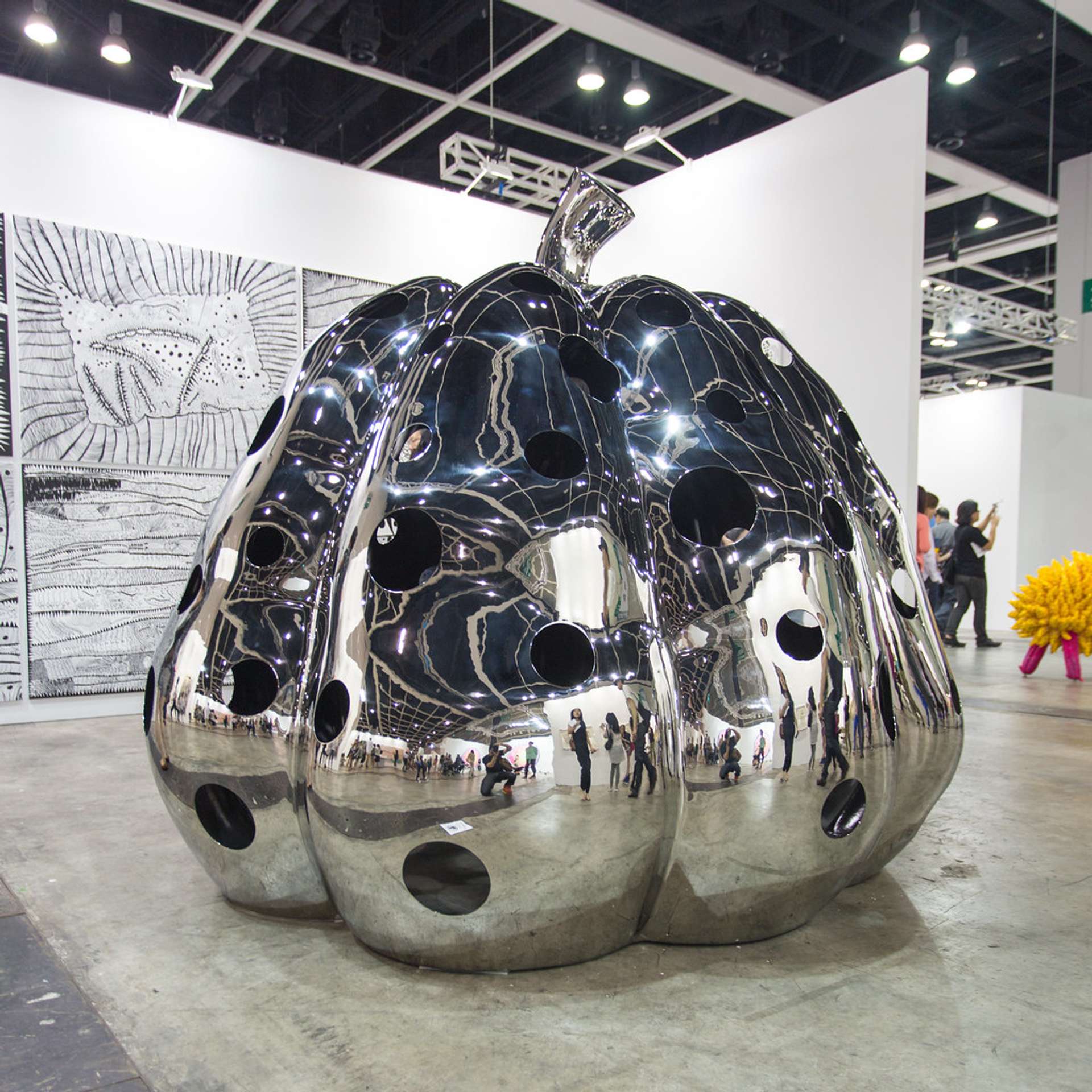 Installation view of a large, chrome finish Pumpin by Yayoi Kusama, at Art Basel Hog Kong.