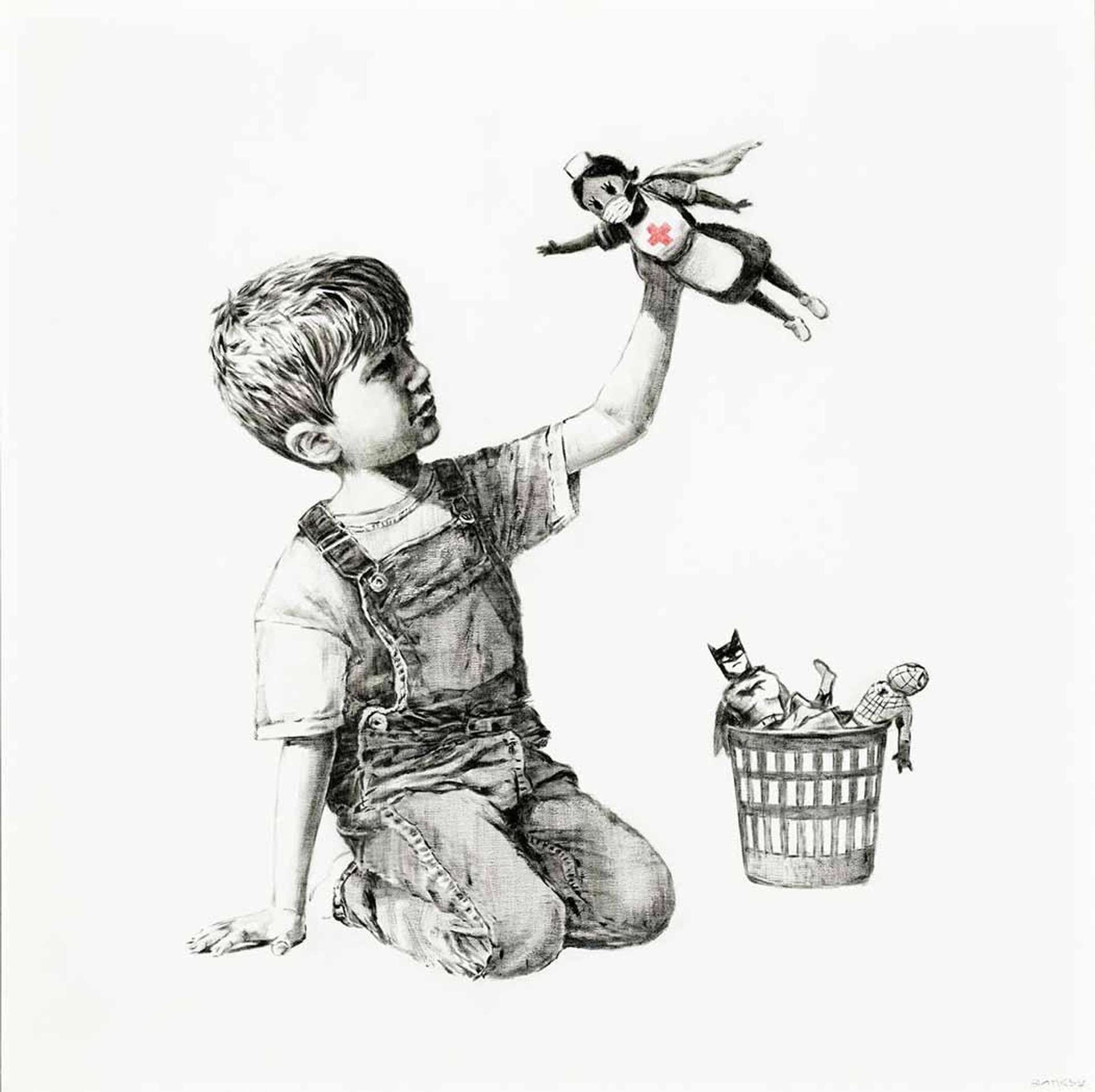 A young boy in dungarees depicted in black and white, playing with a toy wearing a nurse's uniform with a red cross.