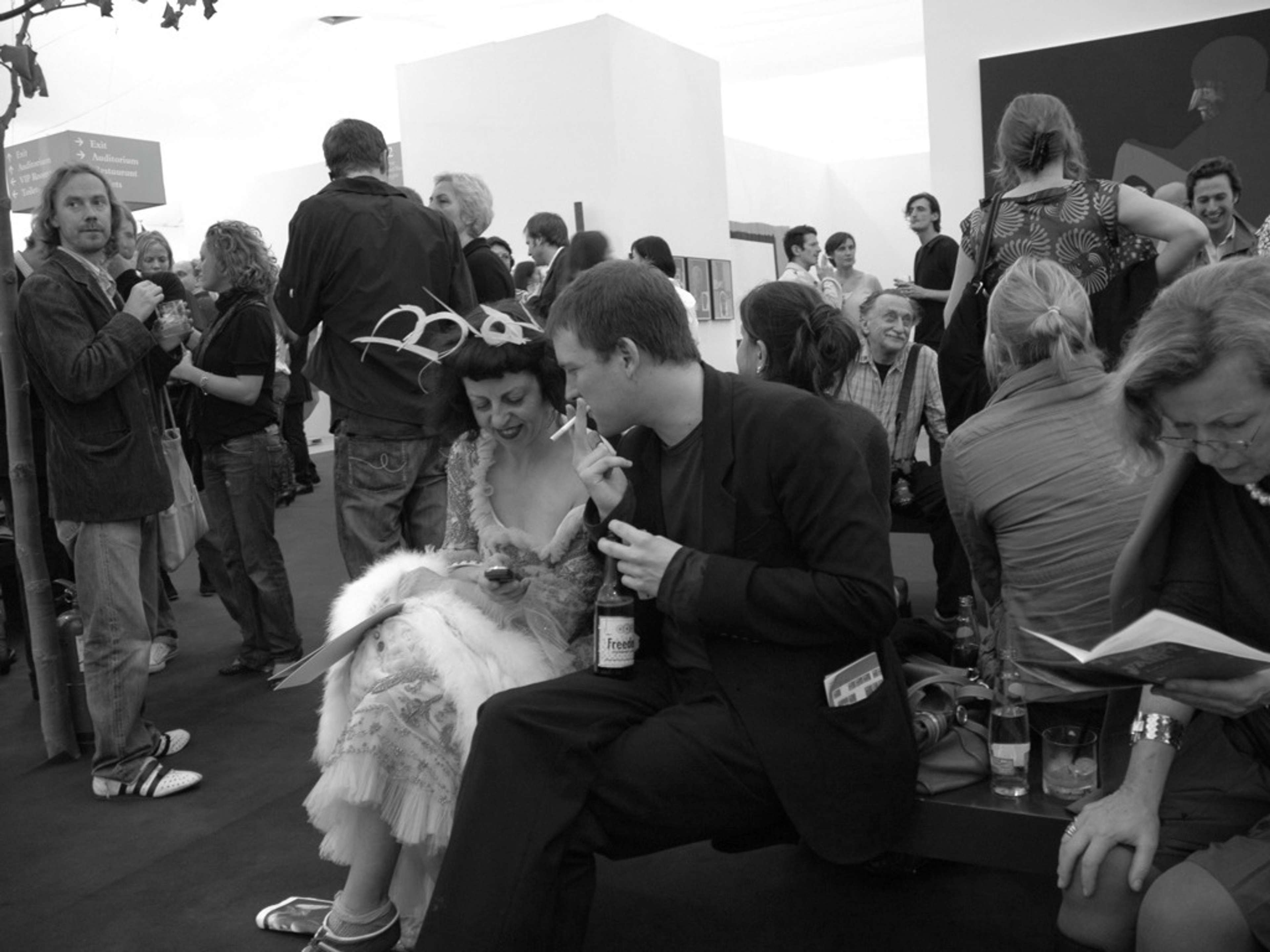 A black and white photograph of people at an art fair