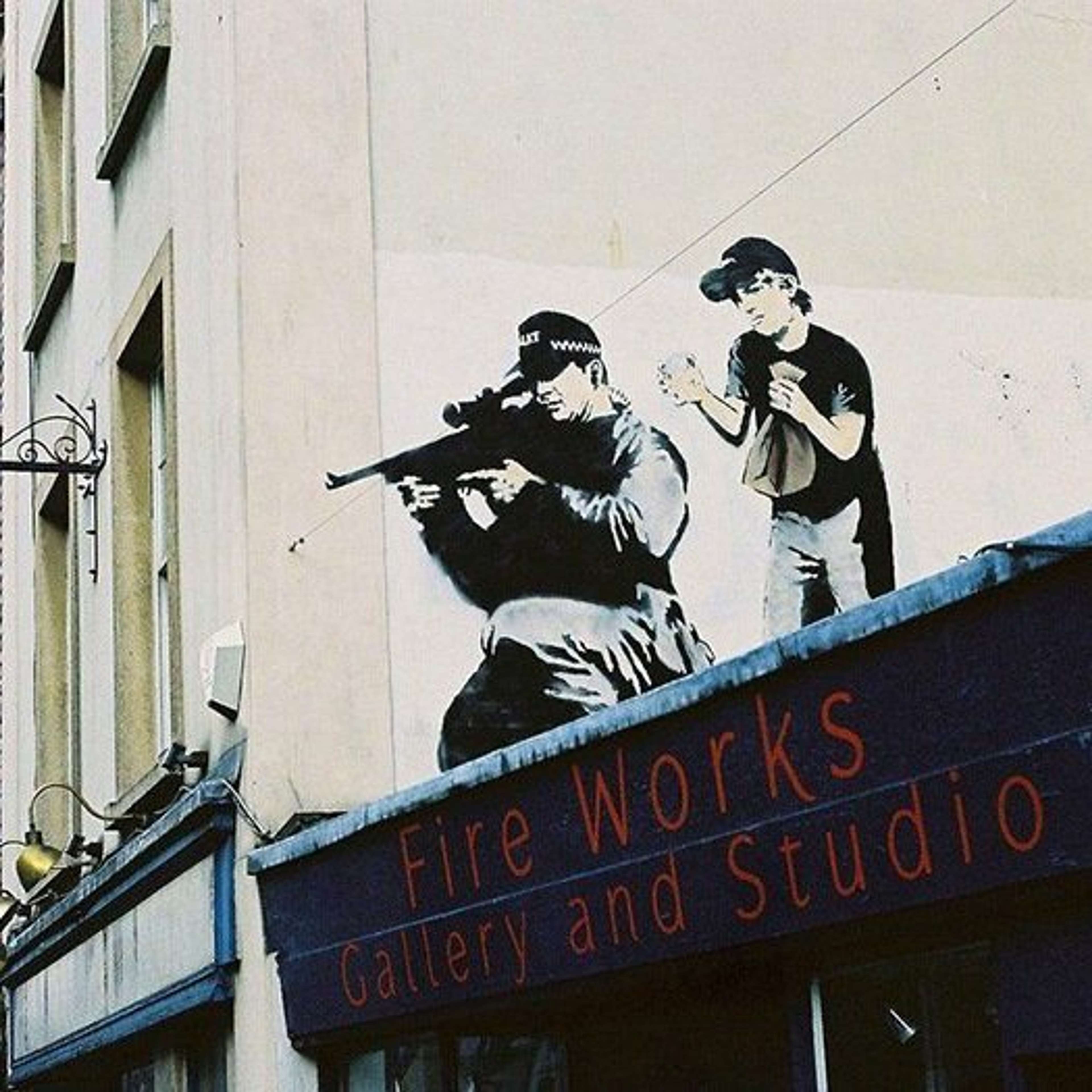 Police Sniper and Paper Bag Boy by Banksy