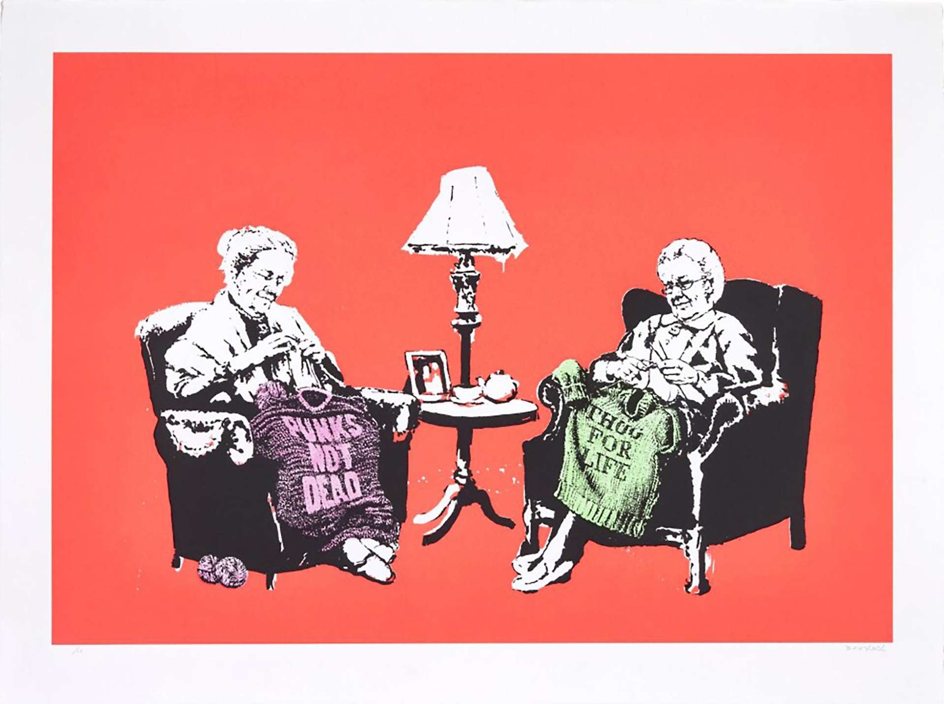 A hand finished screenprint by Banksy depicting two grannies in black and white against a red background, the two grannies knit coloured sweaters which read: “PUNKS NOT DEAD” and “THUG FOR LIFE”