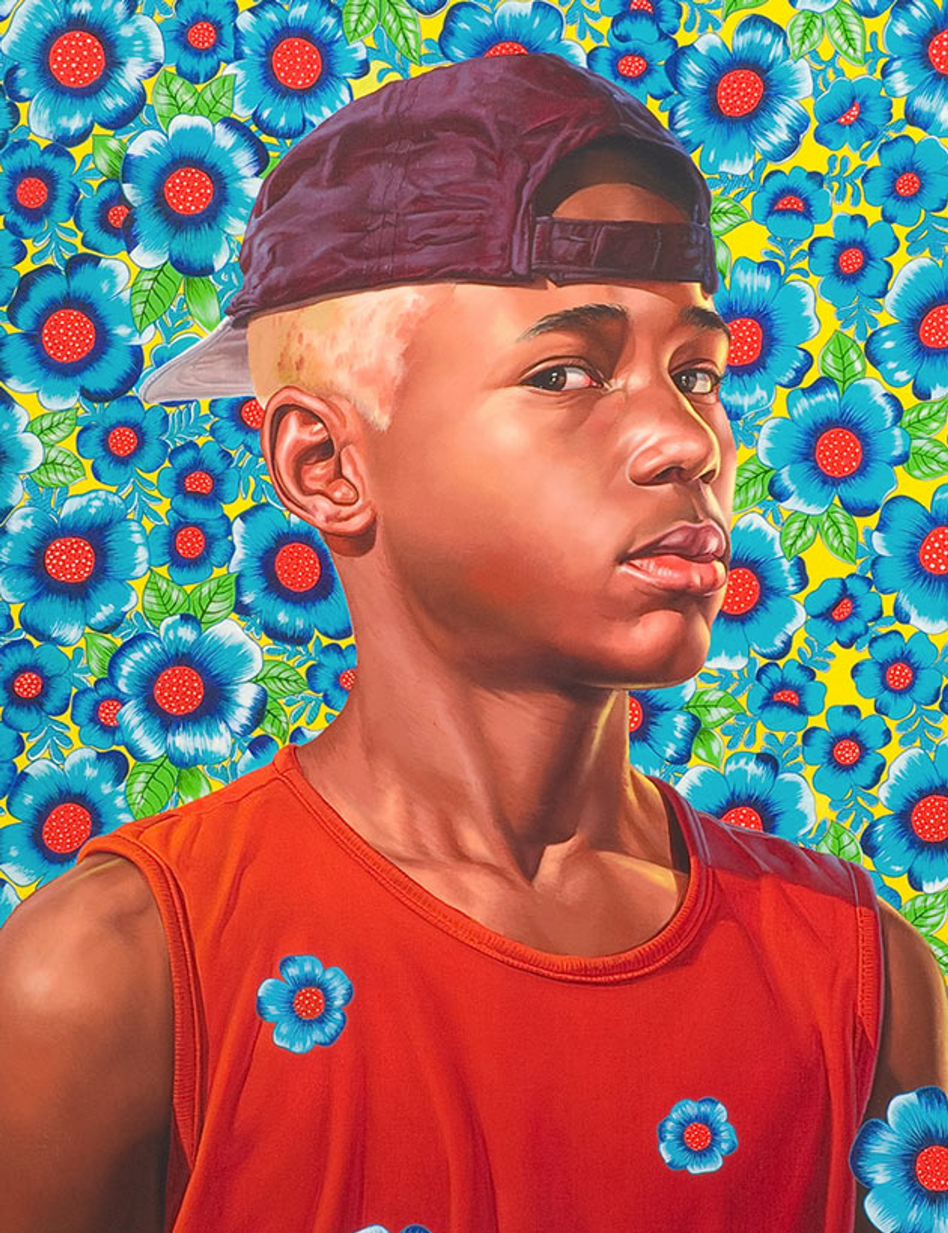 Kehinde Wiley’s Randerson Romulado Cordeiro. A macro portrait of a boy with blonde hair and a baseball cap in black, wearing a red tank top in front of a floral background with the same flowers in front of him, on his shirt.