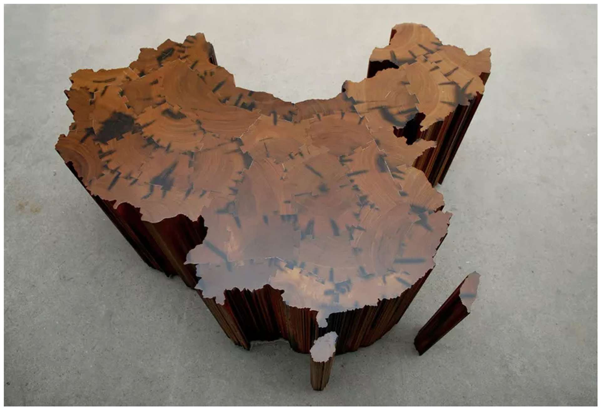  A wooden sculpture representing the shape of the country China when viewed from above.