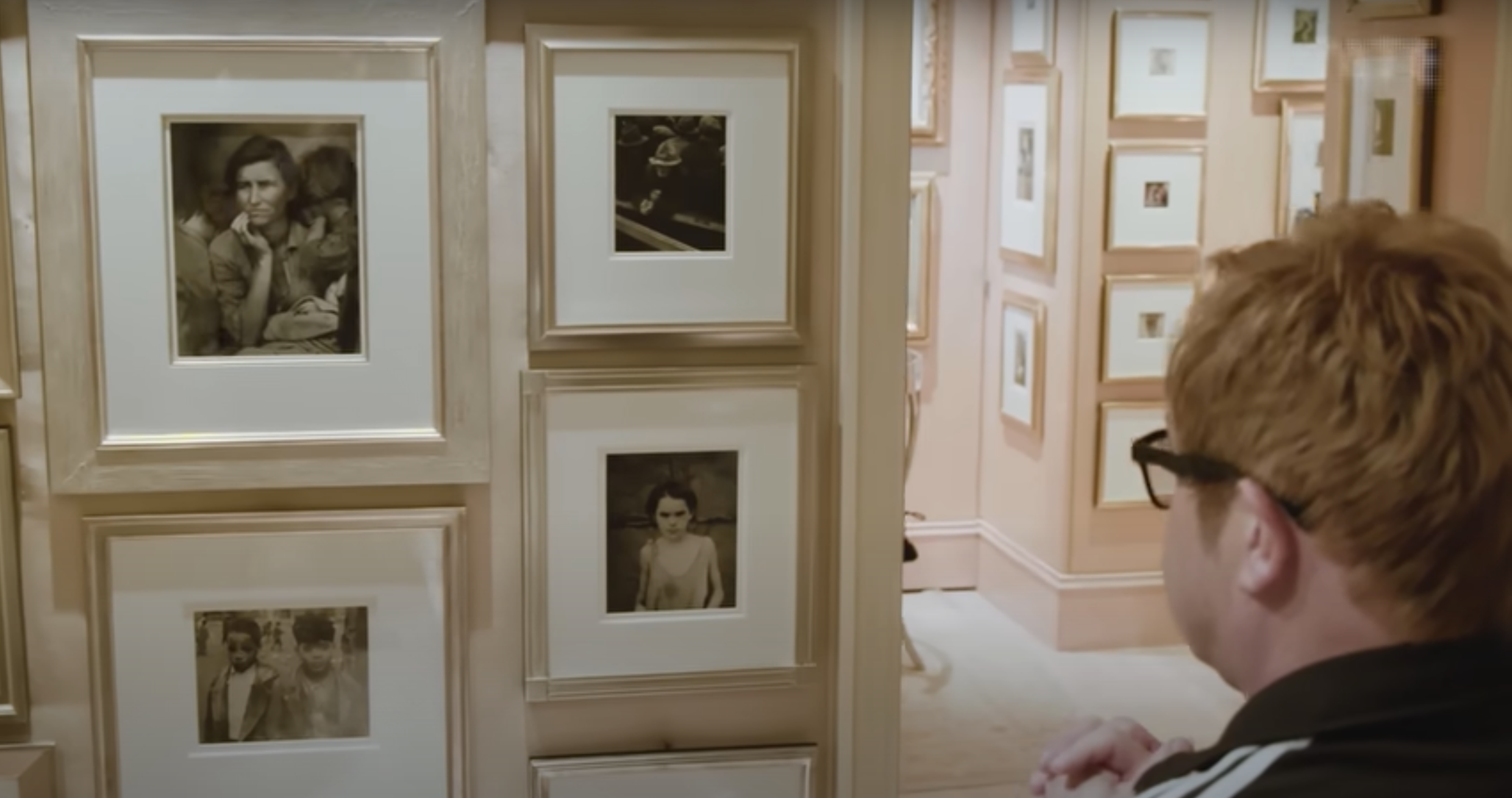 This screenshot shows John looking at Dorothea Lange's Migrant Mother in his house.