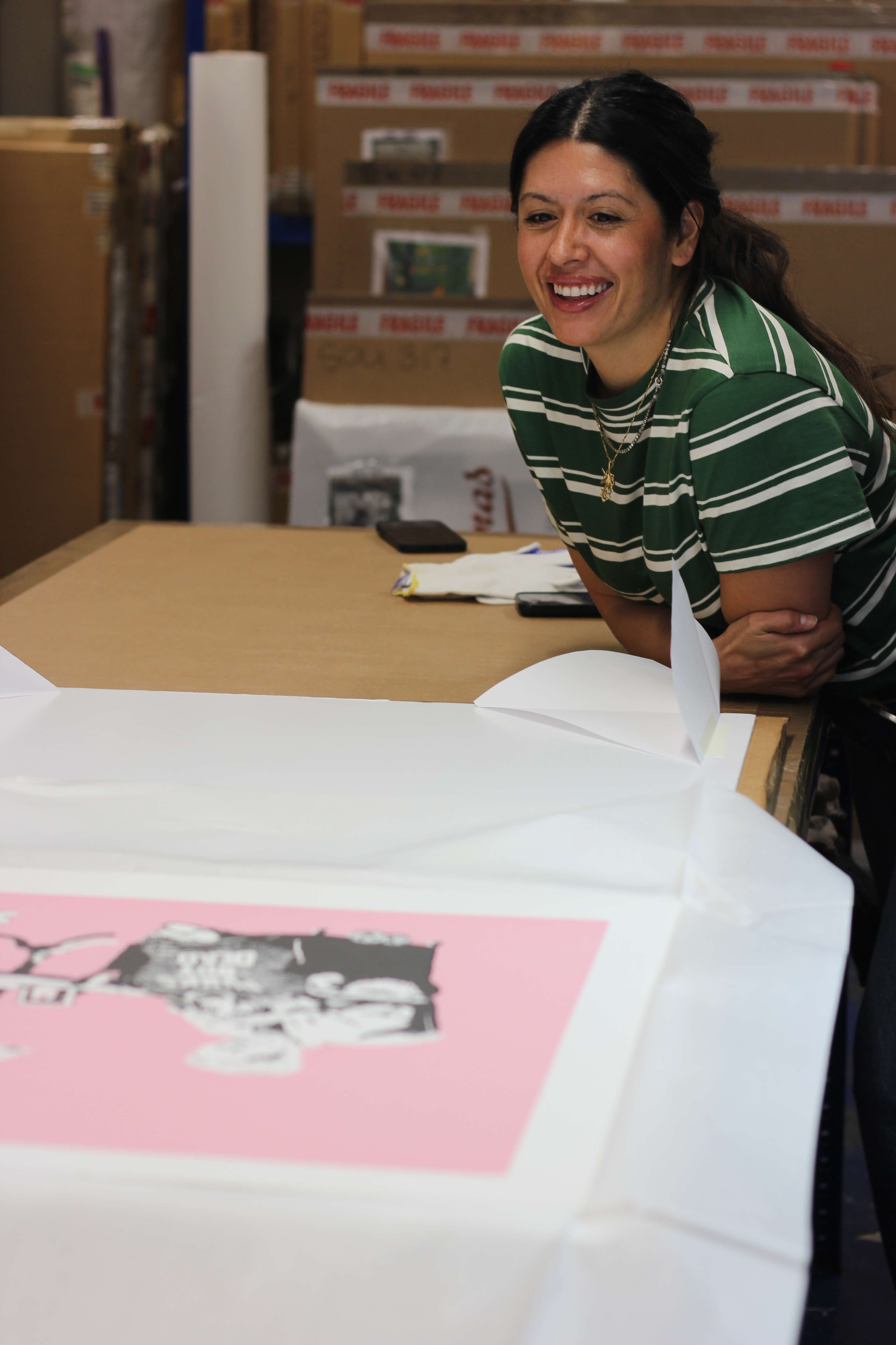 Sheena Carrington looking at a Banksy print 