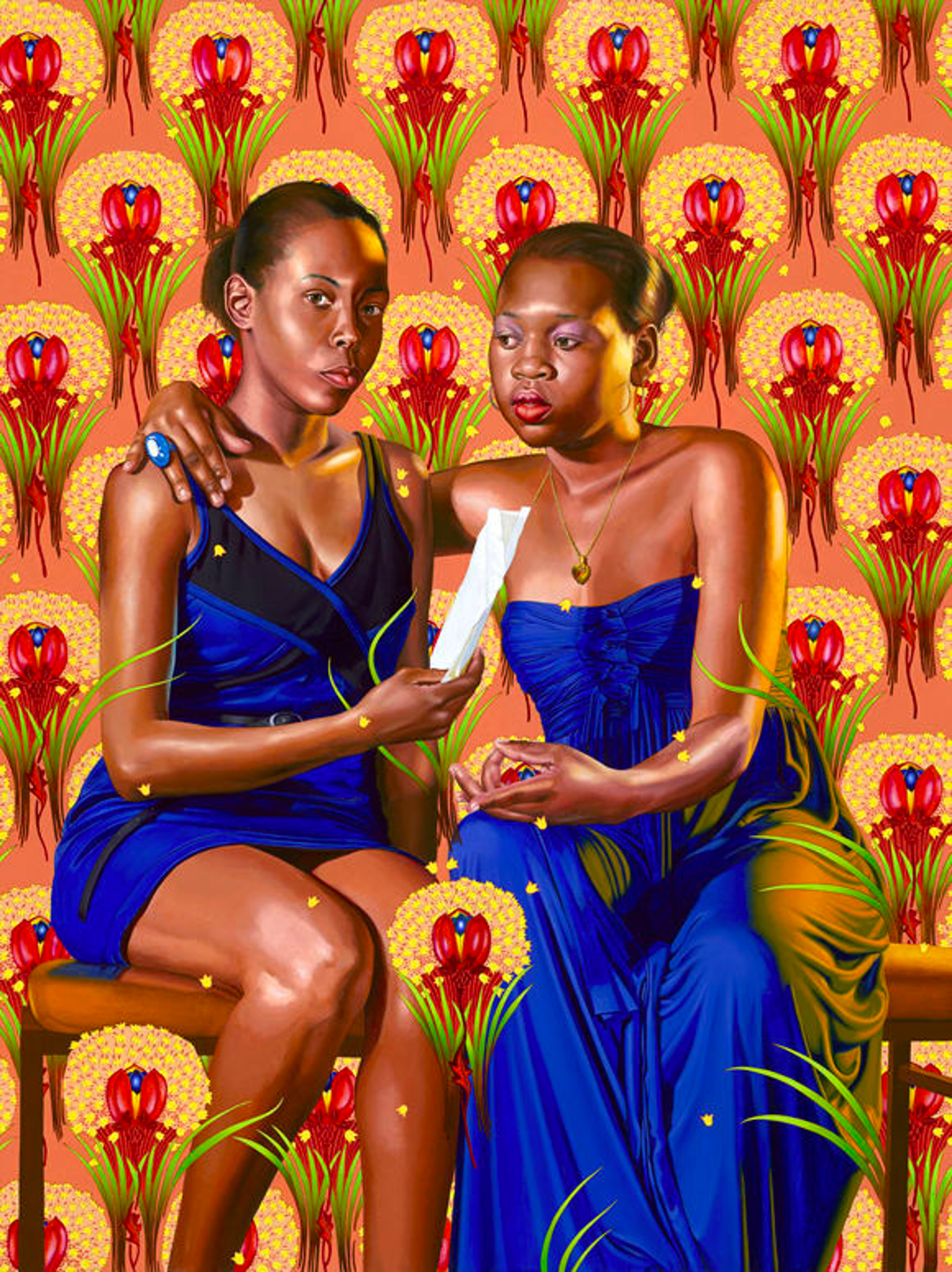 Two black women seated, one facing the viewer, the other looking at a scroll held by the woman on the right. They embrace with the woman on the right's arm around the other's shoulder. They wear blue dresses, seated against a vibrant orange backdrop with red floral wallpaper.