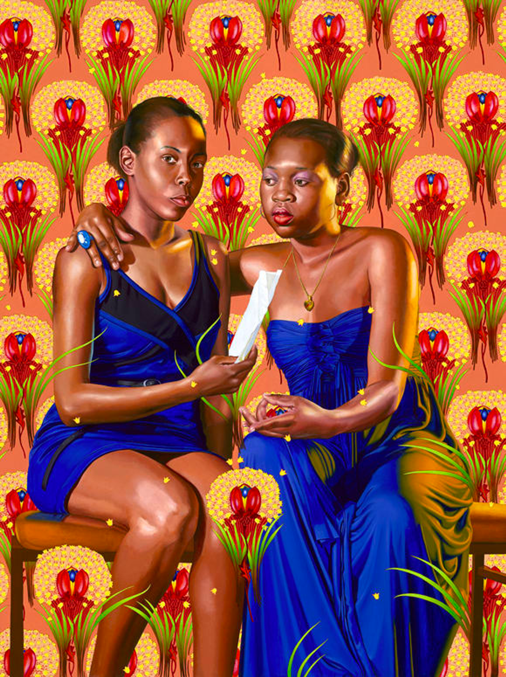 Two black women seated, one facing the viewer, the other looking at a scroll held by the woman on the right. They embrace with the woman on the right's arm around the other's shoulder. They wear blue dresses, seated against a vibrant orange backdrop with red floral wallpaper.