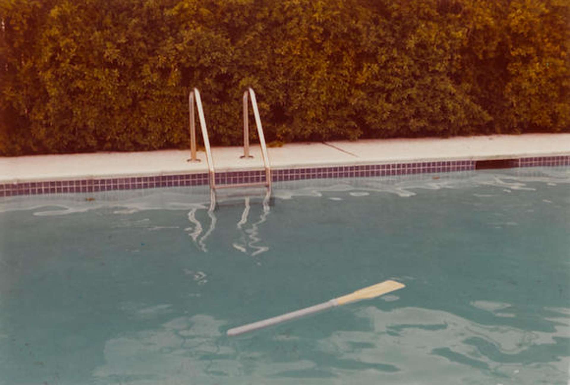 A photograph taken by David Hockney of a swimming pool in California.
