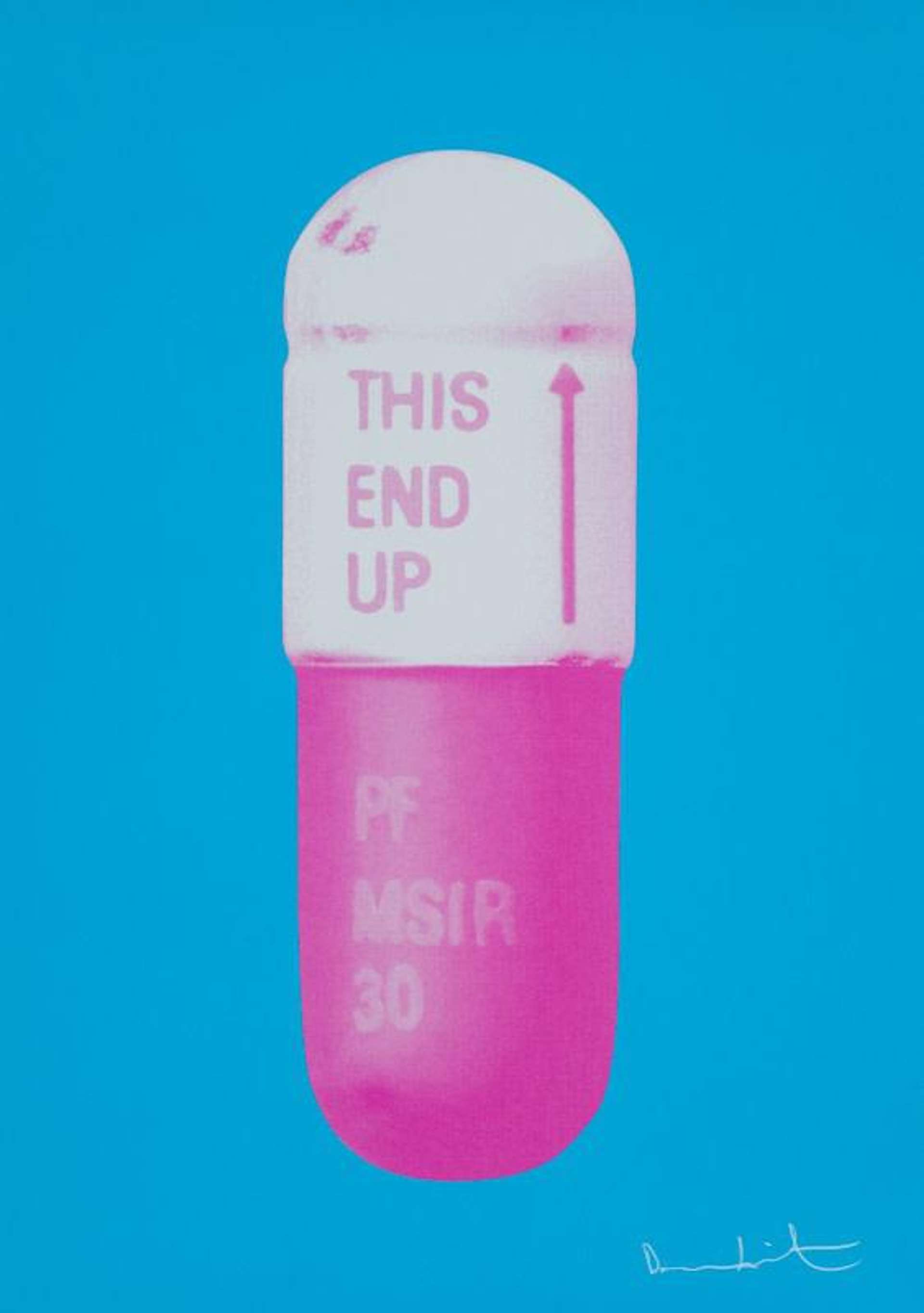 Close up of pill capsule with pink bottom, white top and blue background