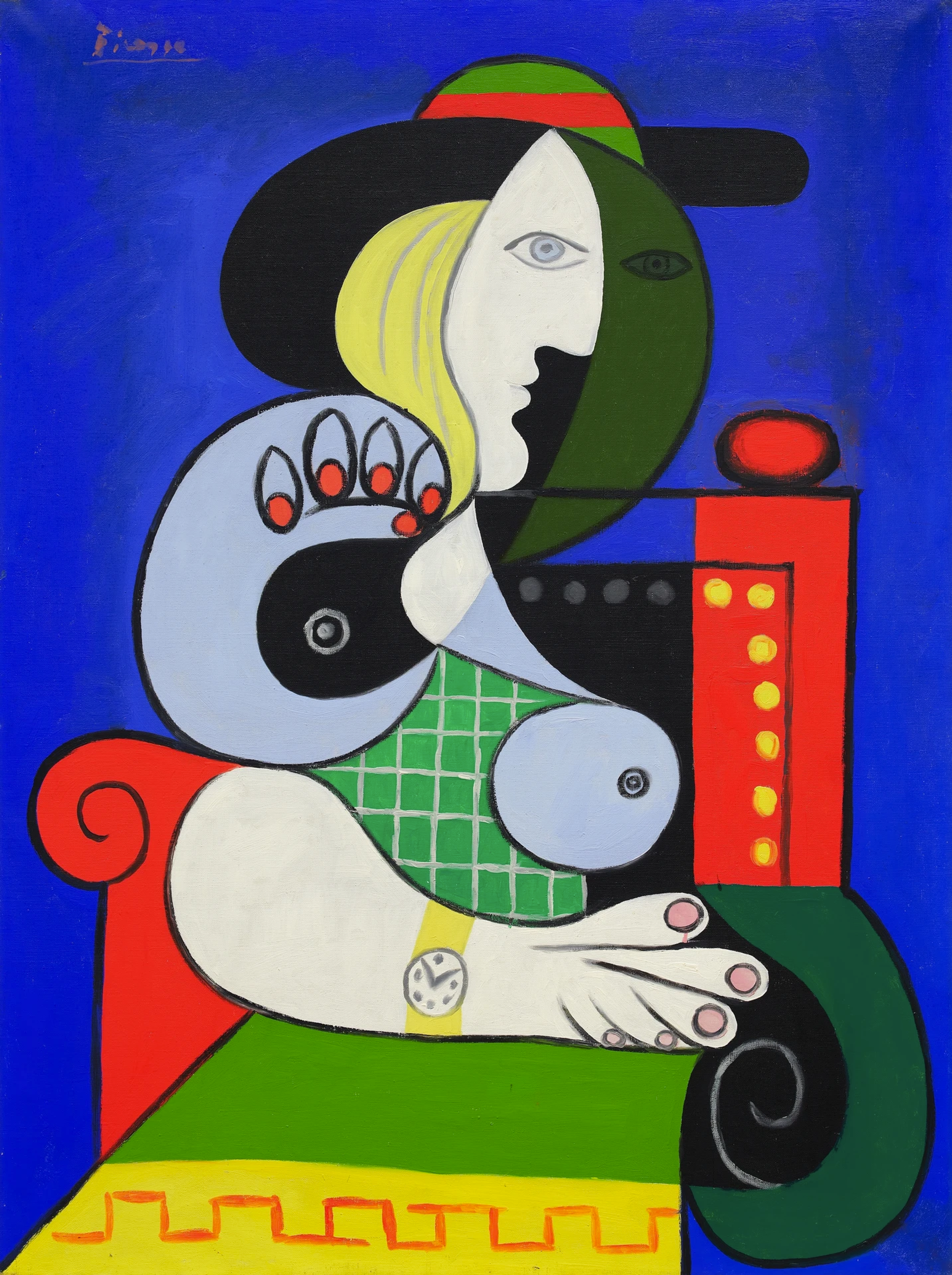 Painting by Pablo Picasso depicting a woman, deconstructed into curvaceous forms of cream, green, yellow, powder blue against a red chair and cobalt blue background.