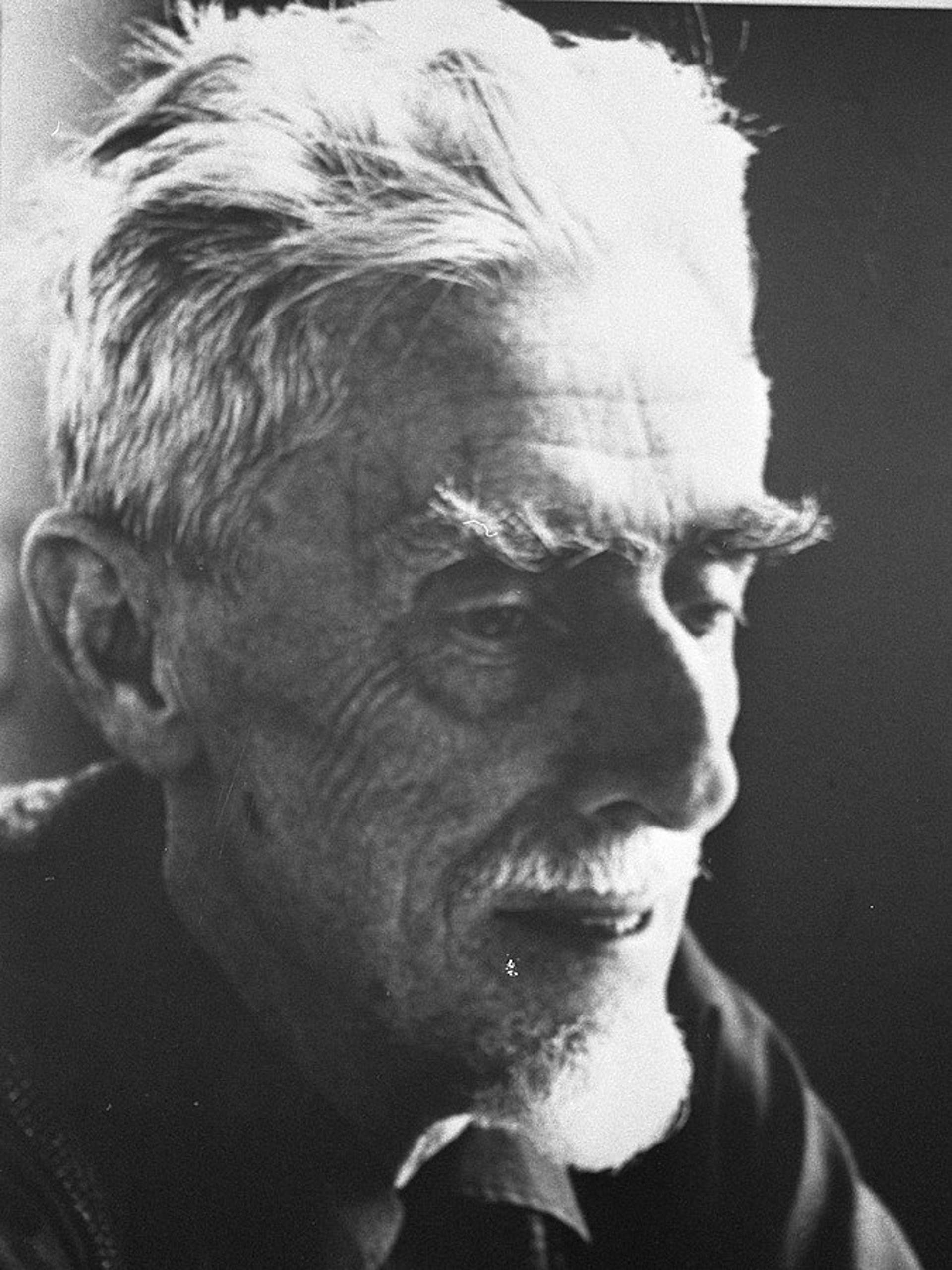 A black and white portrait photograph of Maurits Cornelis Escher.