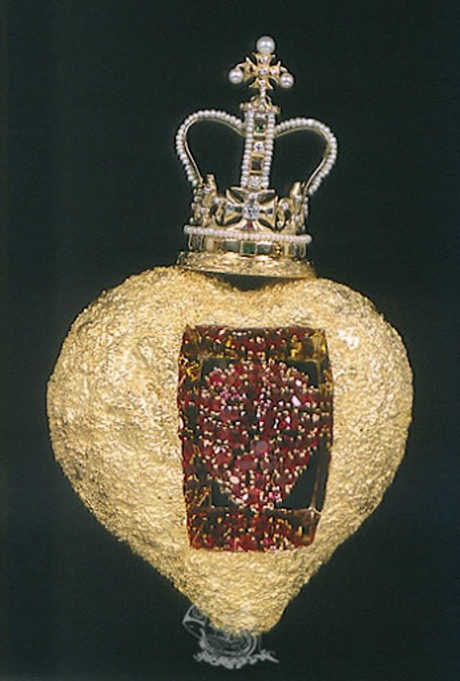 Salvador Dalí’s The Royal Heart. A gold heart with a crown on top and a collection of red gemstones in the centre.