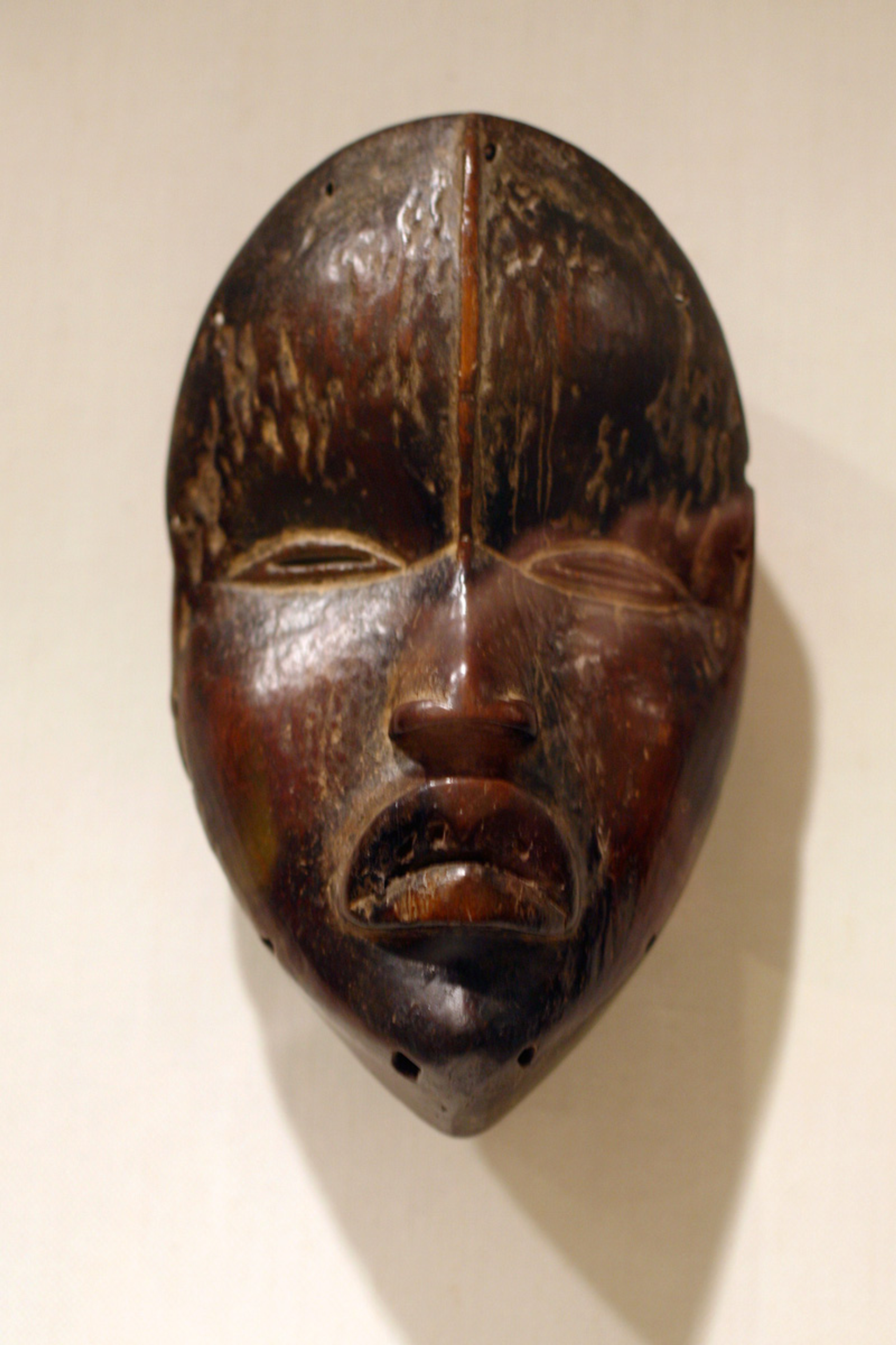 A brown, wooden mask from the Dan tribe of West Africa