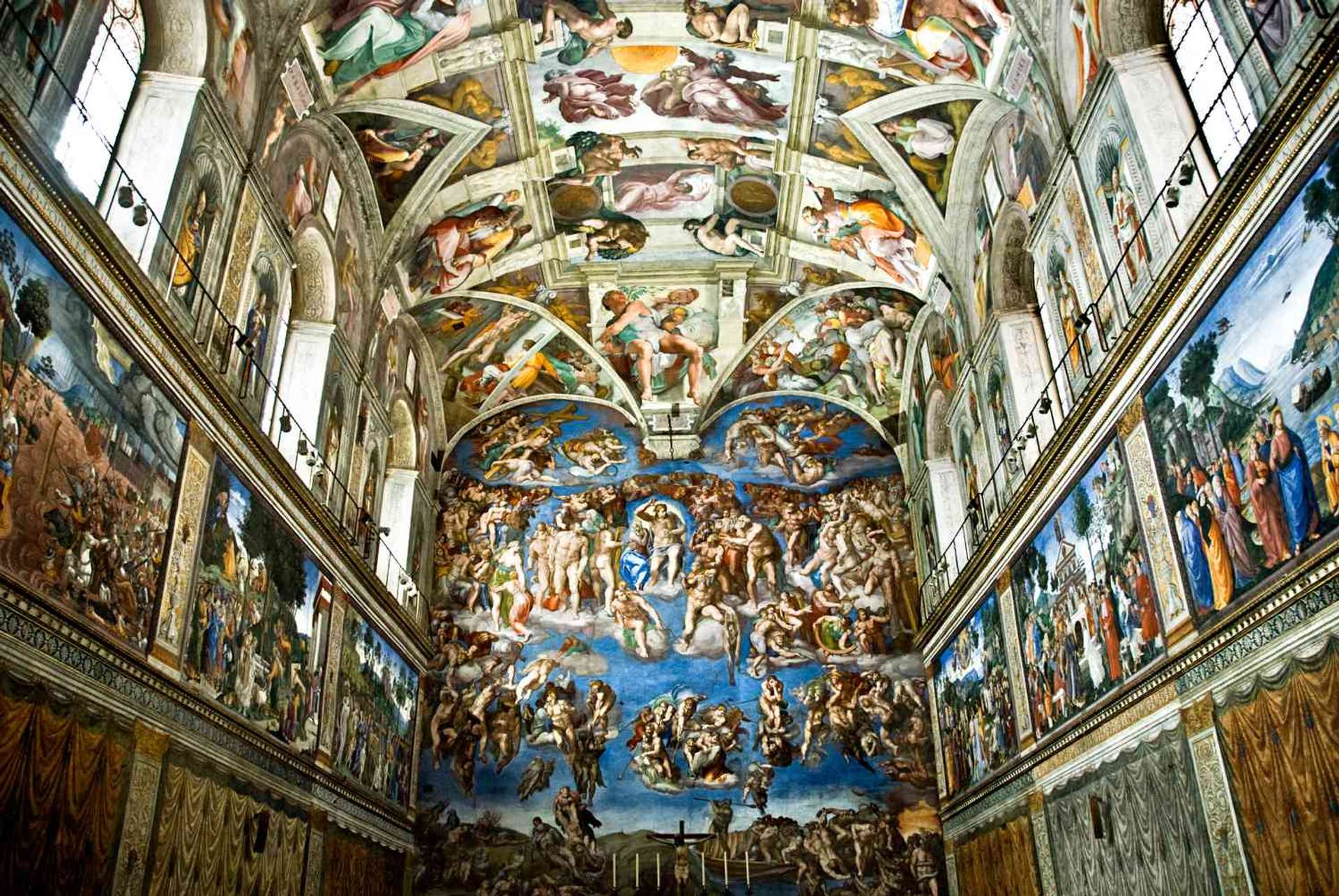 An image of the Sistine Chapel, painted by Michelangelo. It is a detailed depiction of several biblical scenes, including the final judgement in the main wall shown here.