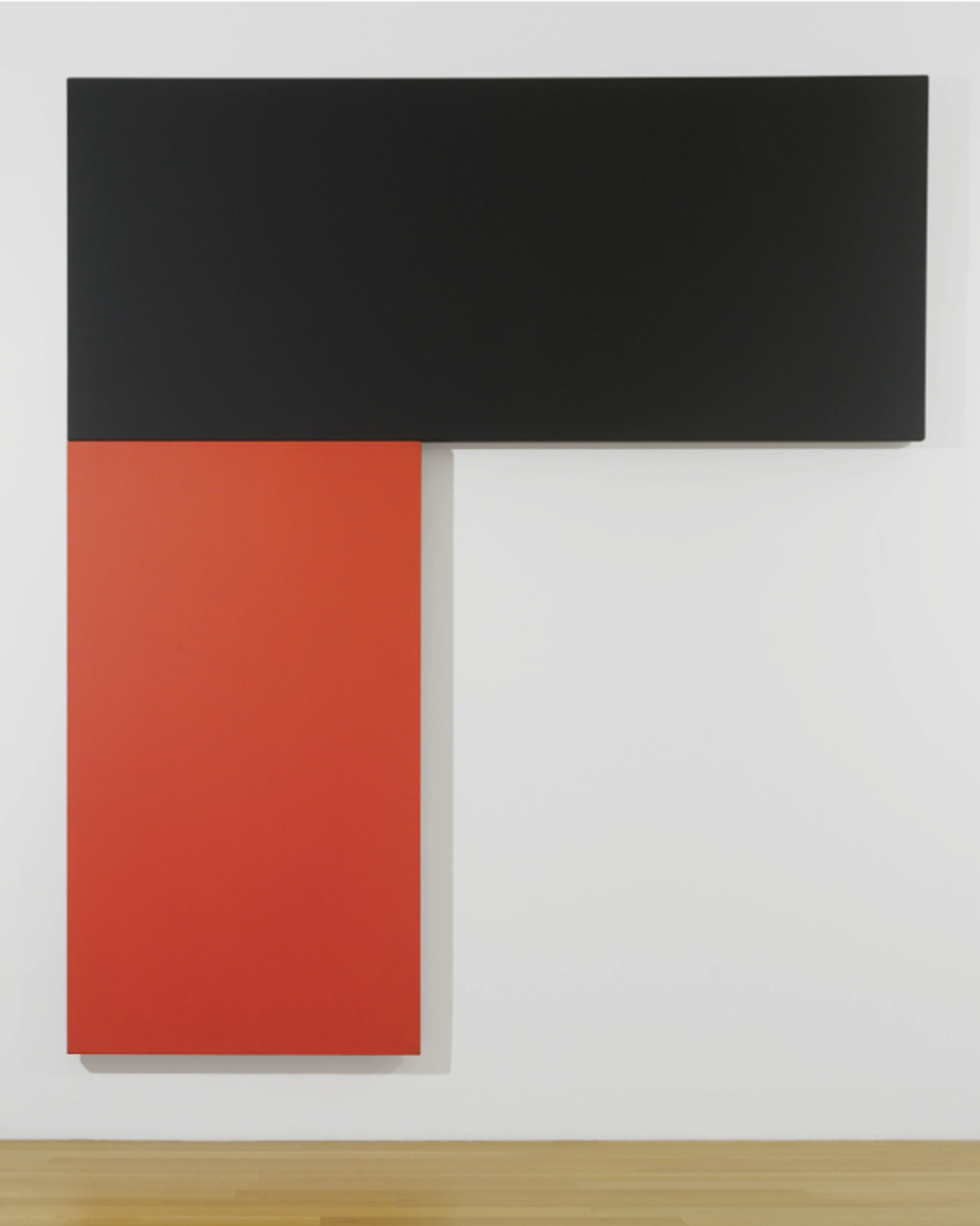 Two rectangular canvases attached perpendicular to each other, to form an upside down “L.” The lower of the two canvases is painted entirely red, while the upper horizontal canvas is black.