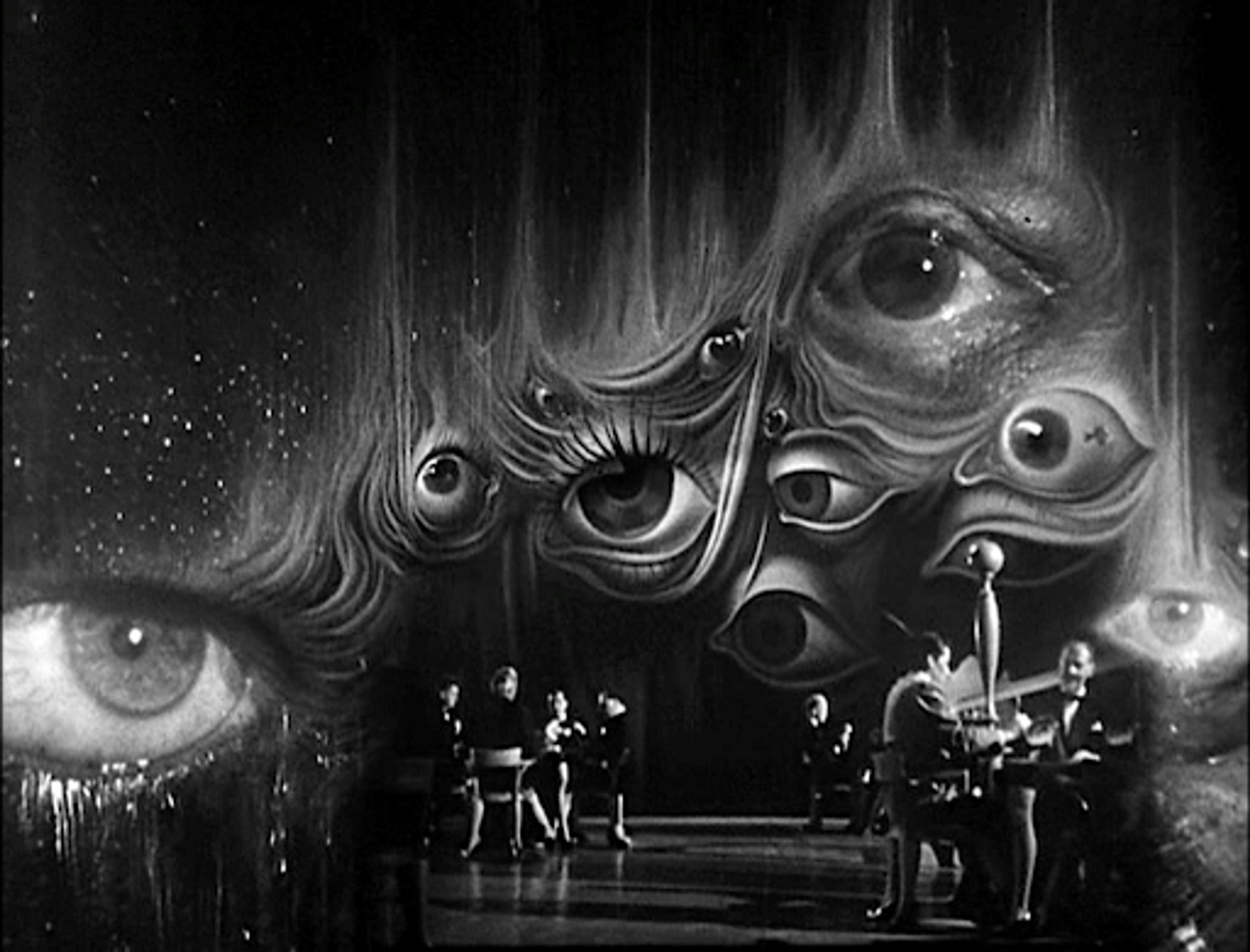 Photogramme en noir et blanc du film "Spellbound", montrant un arrière-plan composé d'yeux ouverts.