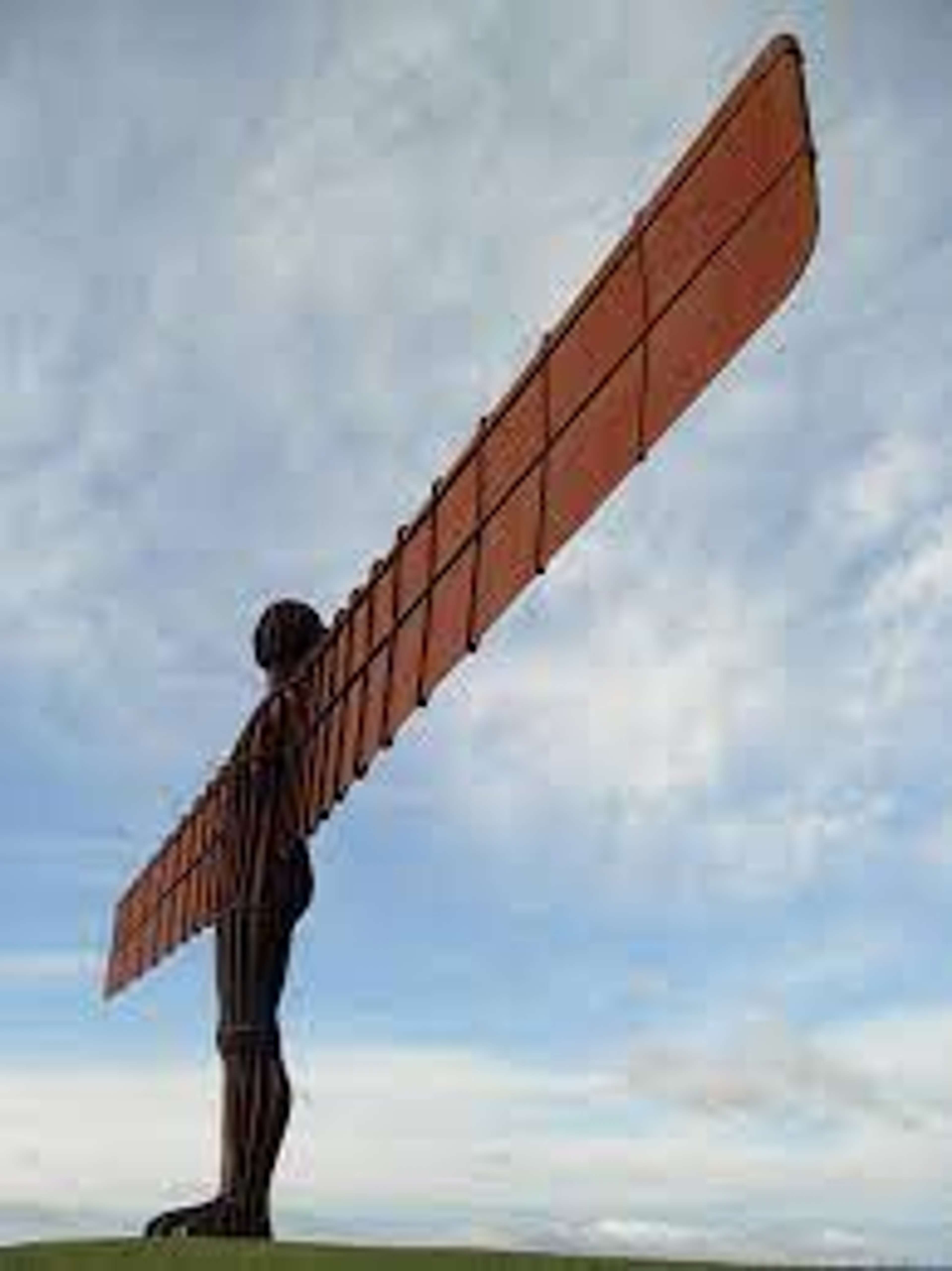 La sculpture d'Antony Gormley, « Angel of the North » (1994), se détache en silhouette sur un ciel bleu.